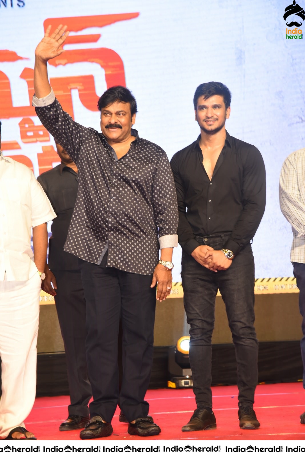 Actor Nikhil Siddhartha on the stage with Mega Star