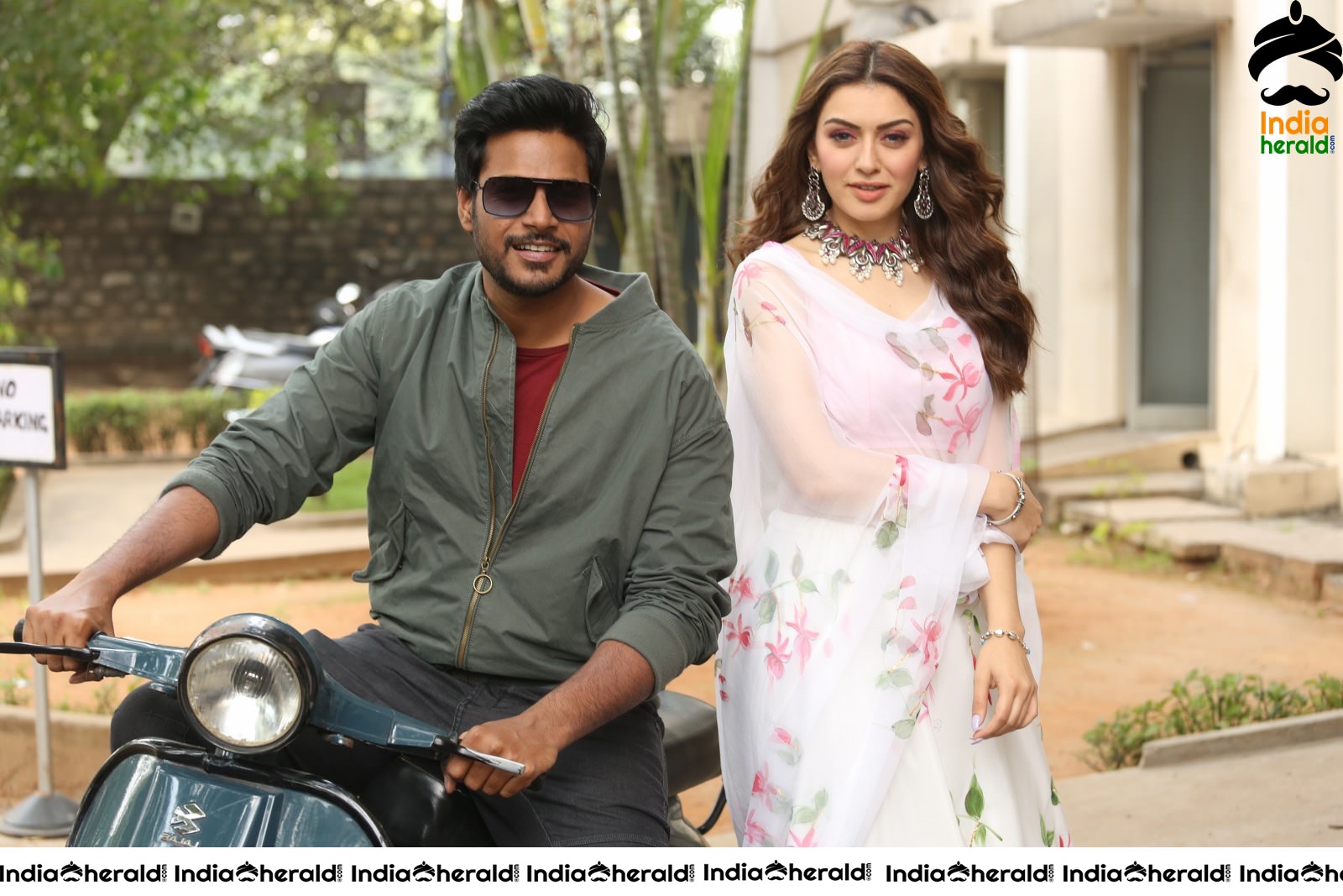Actor Sundeep Kishan takes Photos along with Hansika sitting behind him in a Scooter Set 1