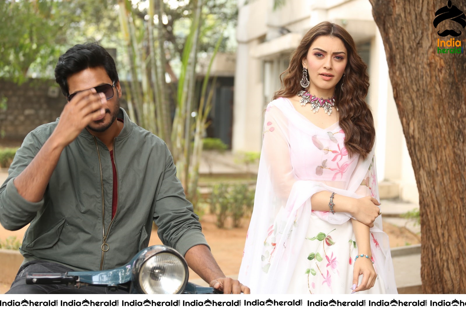 Actor Sundeep Kishan takes Photos along with Hansika sitting behind him in a Scooter Set 1