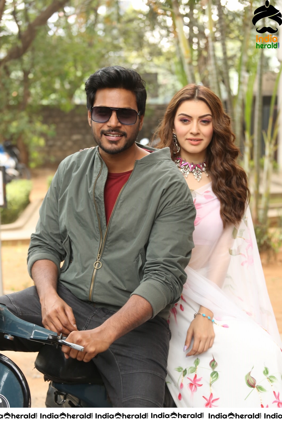 Actor Sundeep Kishan takes Photos along with Hansika sitting behind him in a Scooter Set 2