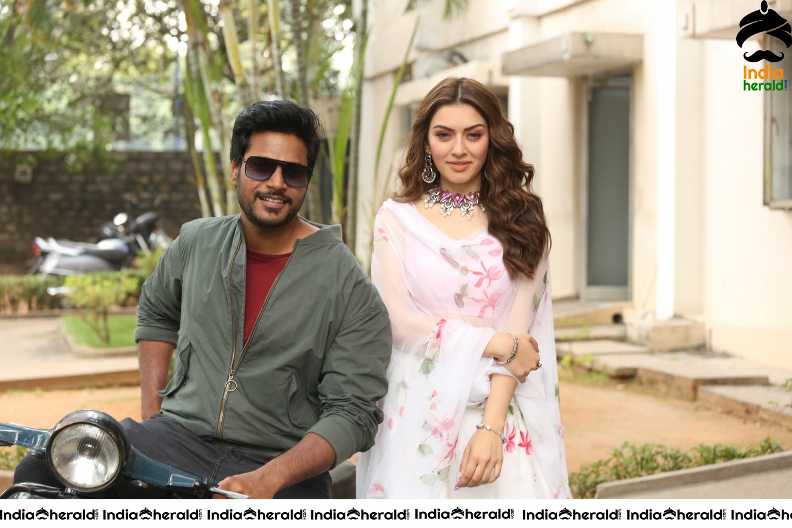 Actor Sundeep Kishan takes Photos along with Hansika sitting behind him in a Scooter Set 2