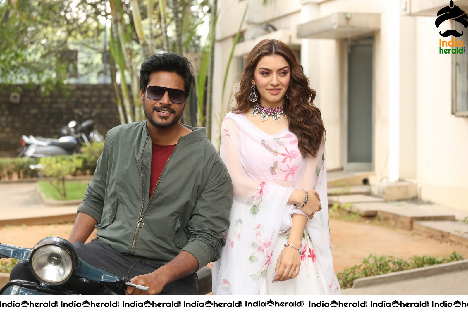 Actor Sundeep Kishan takes Photos along with Hansika sitting behind him in a Scooter Set 2