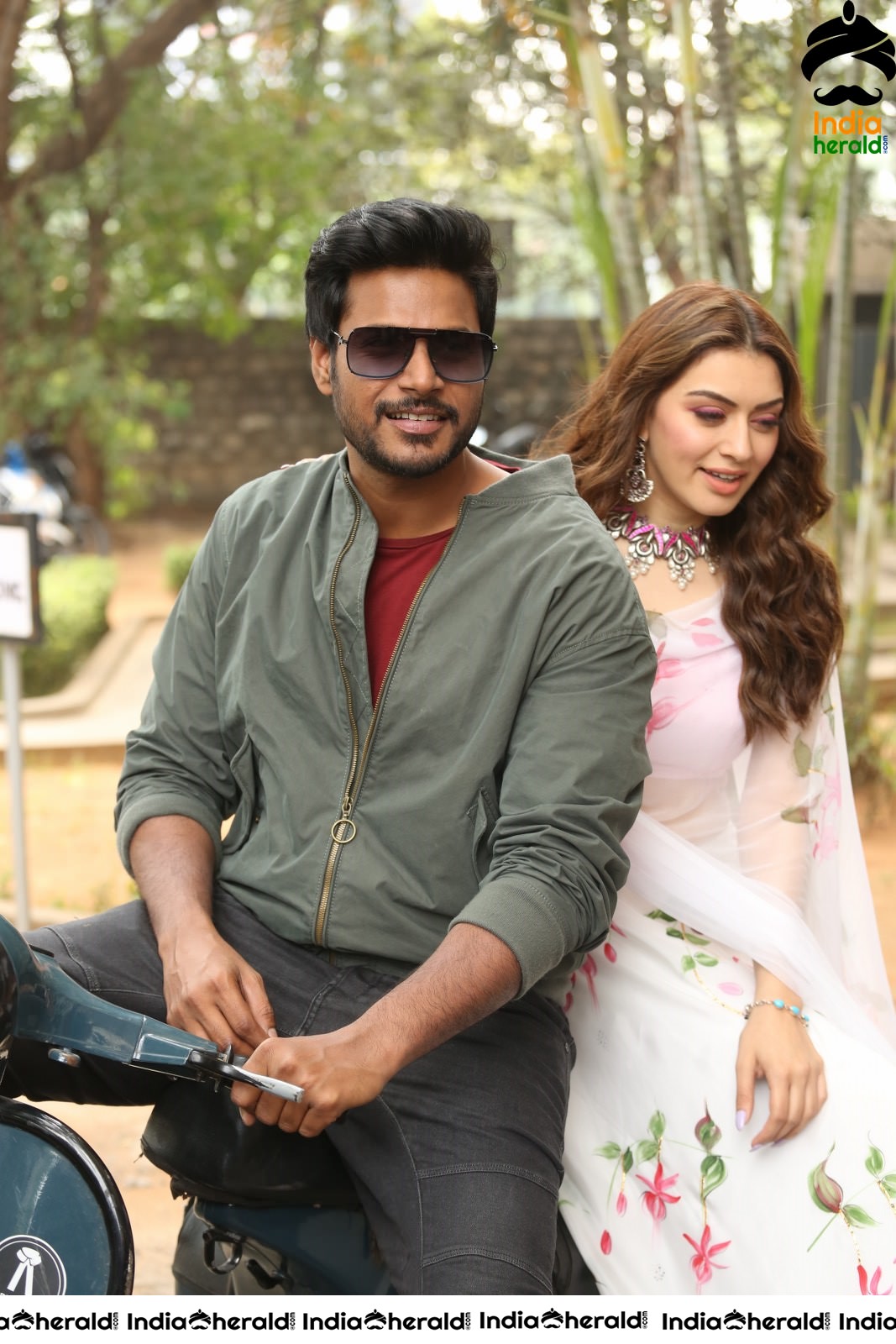 Actor Sundeep Kishan takes Photos along with Hansika sitting behind him in a Scooter Set 2