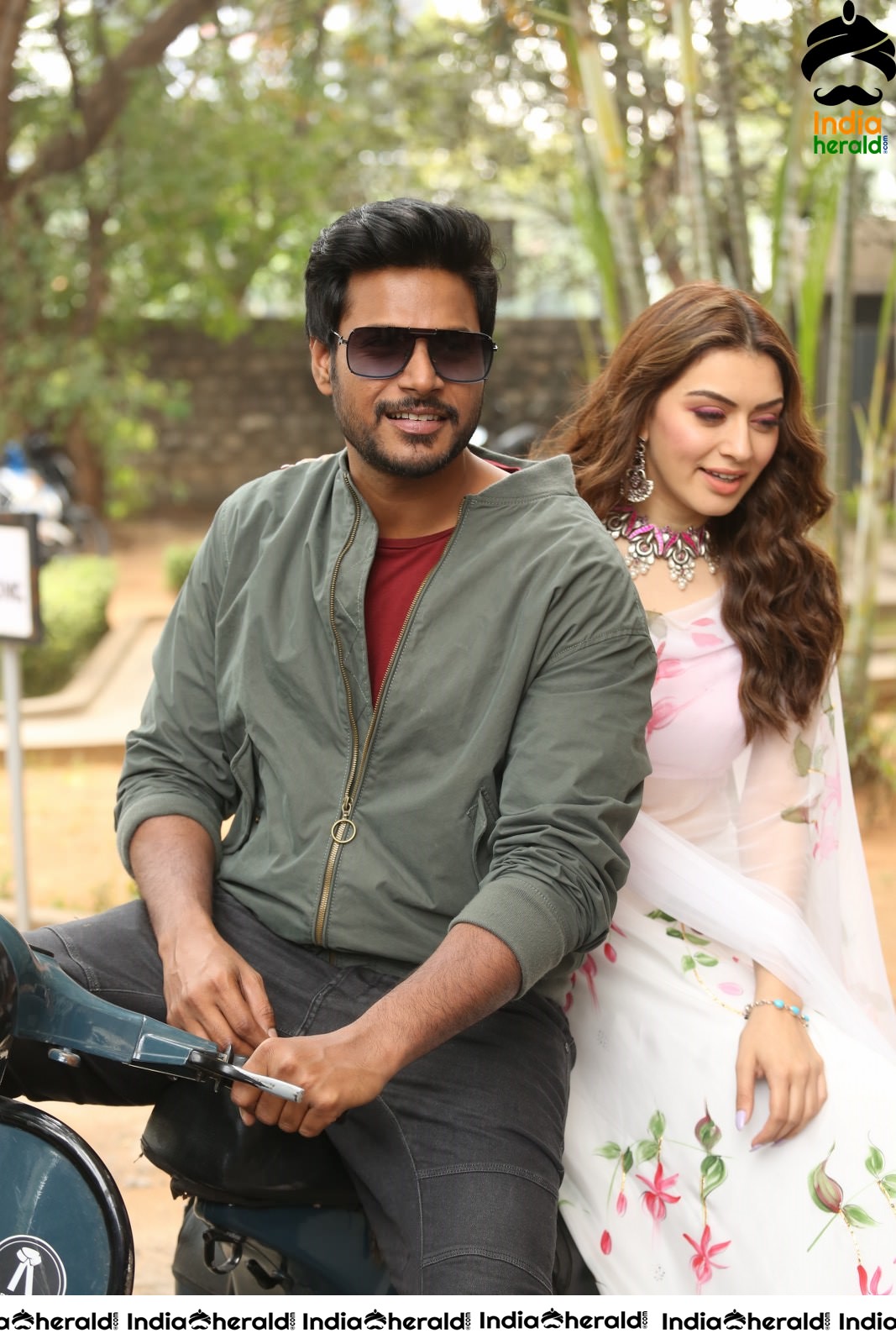 Actor Sundeep Kishan takes Photos along with Hansika sitting behind him in a Scooter Set 2