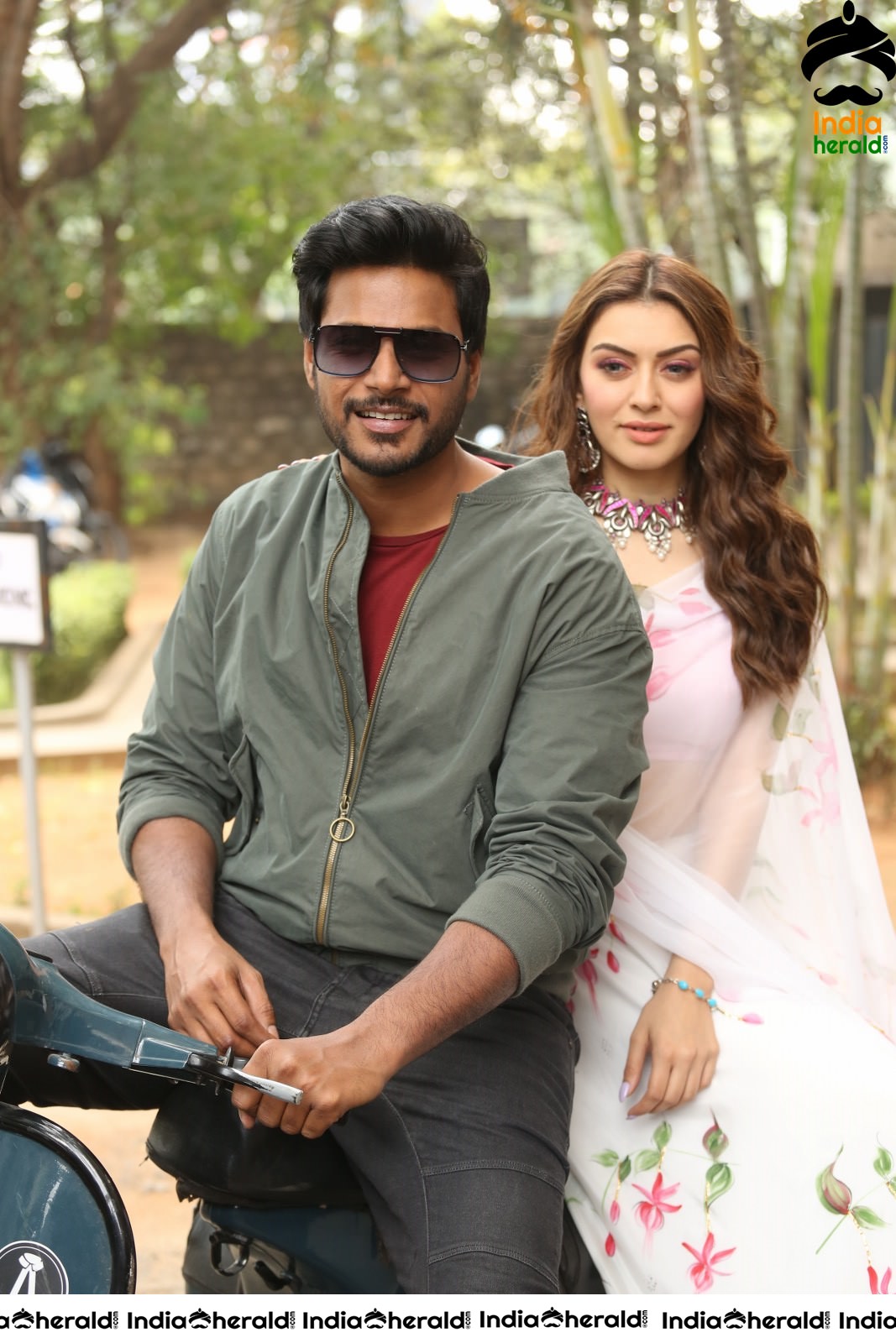 Actor Sundeep Kishan takes Photos along with Hansika sitting behind him in a Scooter Set 2