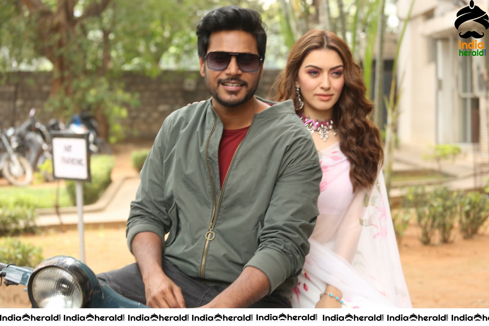 Actor Sundeep Kishan takes Photos along with Hansika sitting behind him in a Scooter Set 2