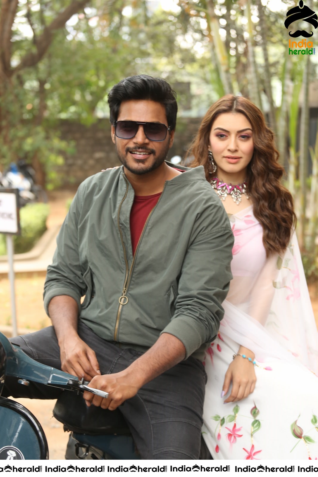 Actor Sundeep Kishan takes Photos along with Hansika sitting behind him in a Scooter Set 2