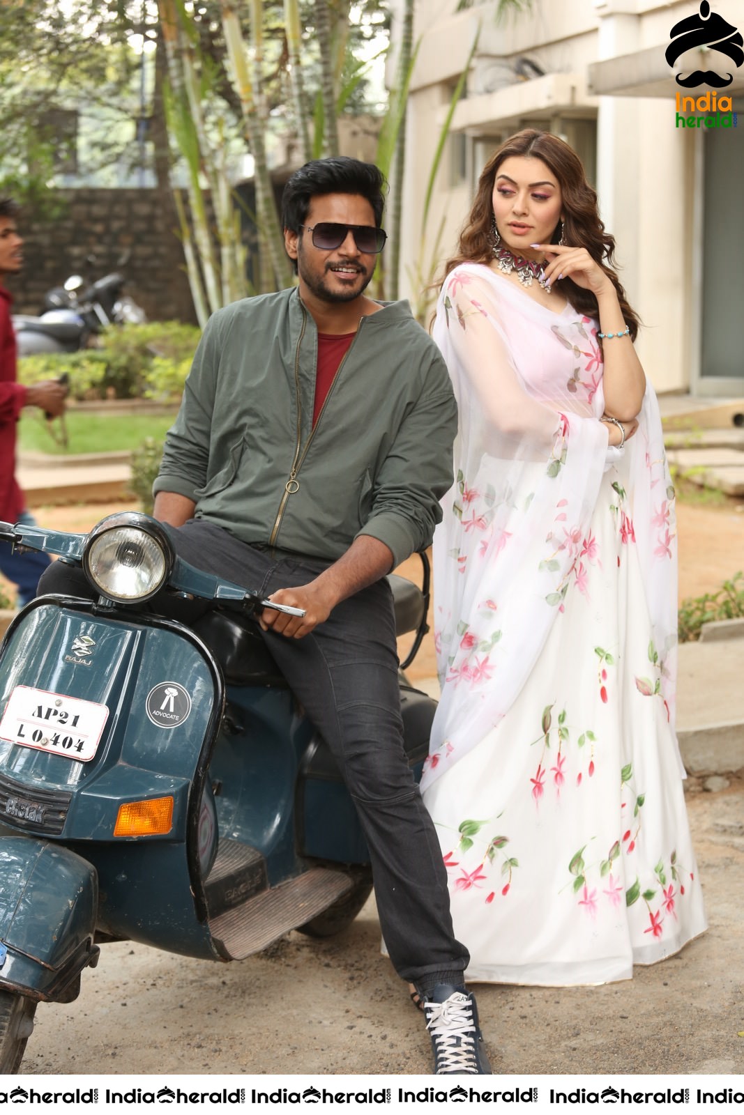 Actor Sundeep Kishan takes Photos along with Hansika sitting behind him in a Scooter Set 2