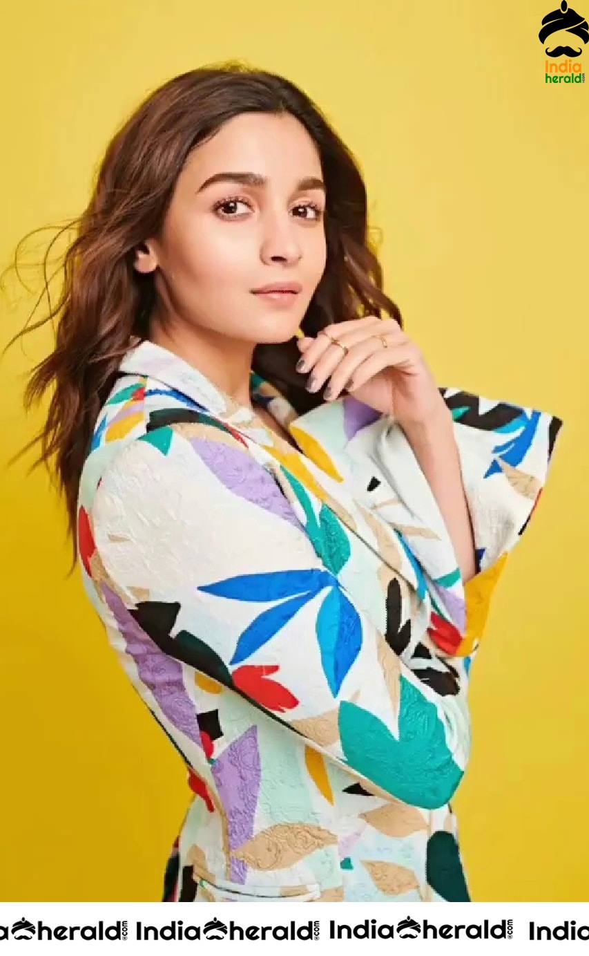 Alia Bhatt Shows her Teasing Cleavage in a Black Brassiere and a Funky Colored Coat