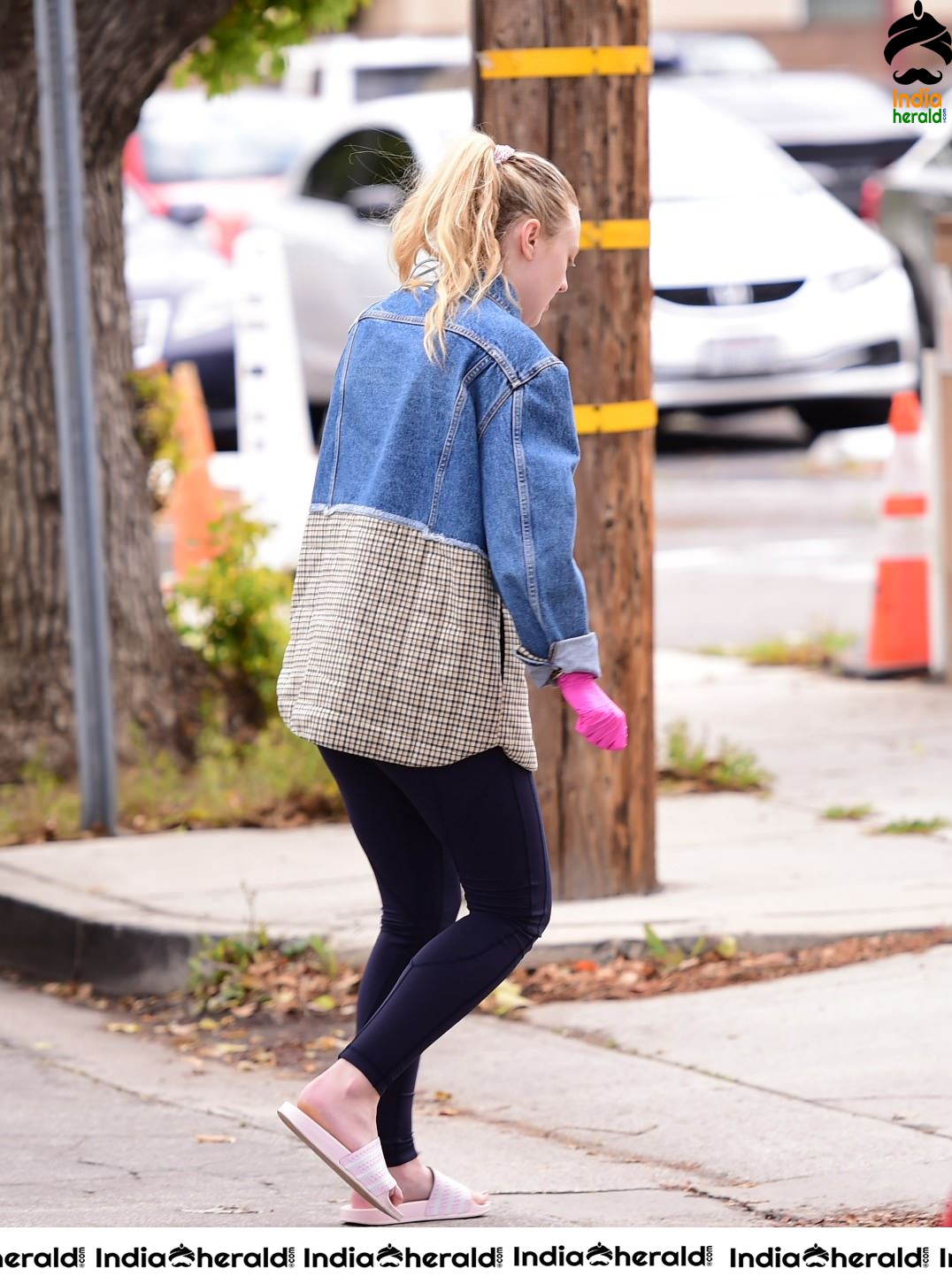 Dakota Fanning Wears pink surgical gloves while stepping out in Los Angeles