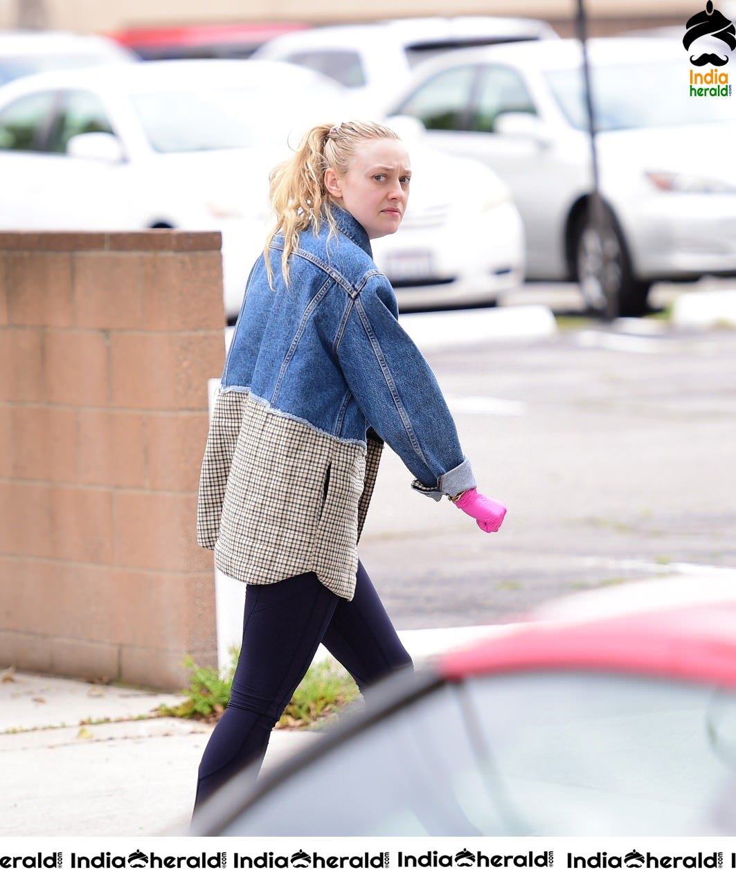 Dakota Fanning Wears pink surgical gloves while stepping out in Los Angeles