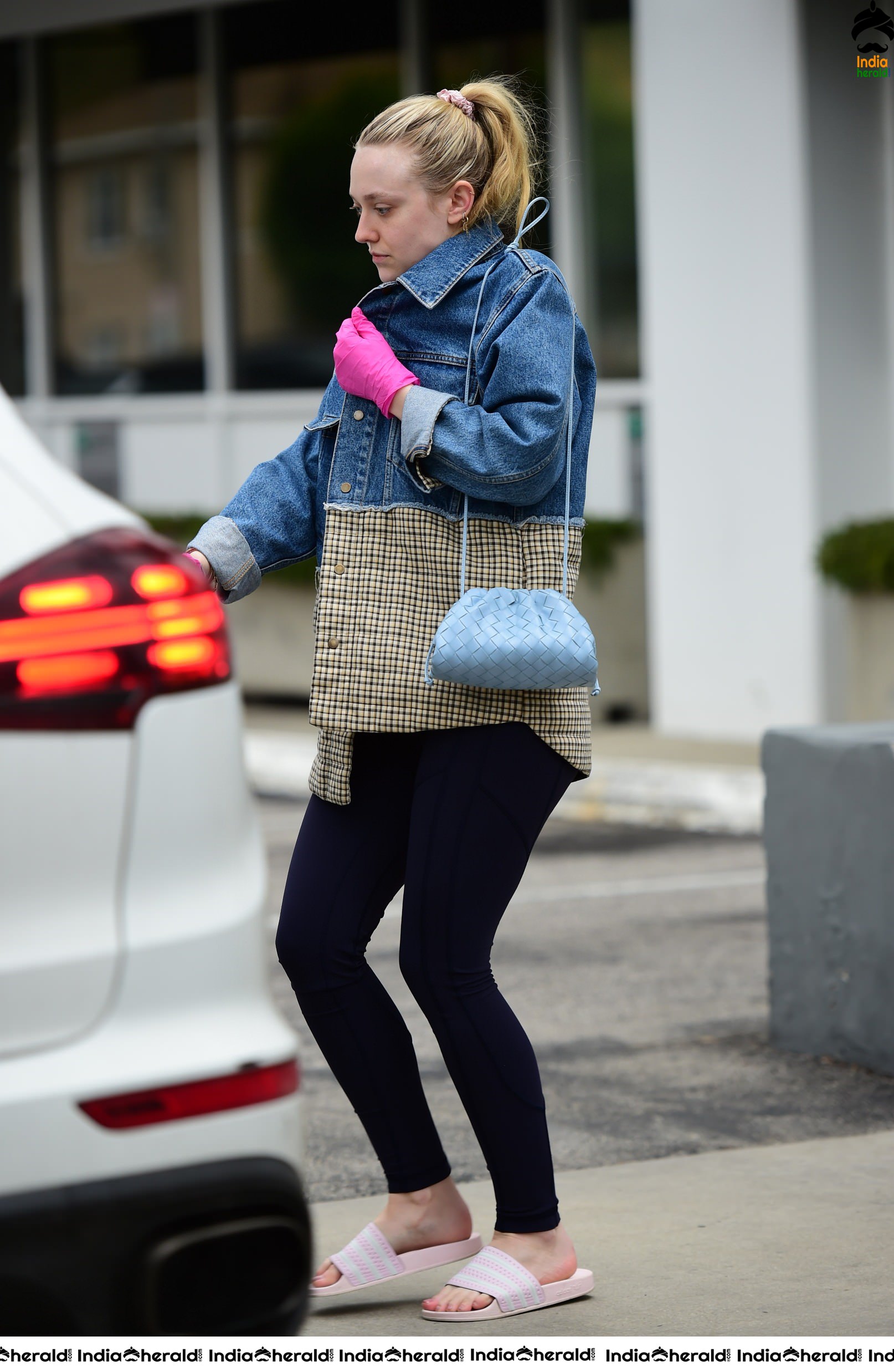 Dakota Fanning Wears pink surgical gloves while stepping out in Los Angeles