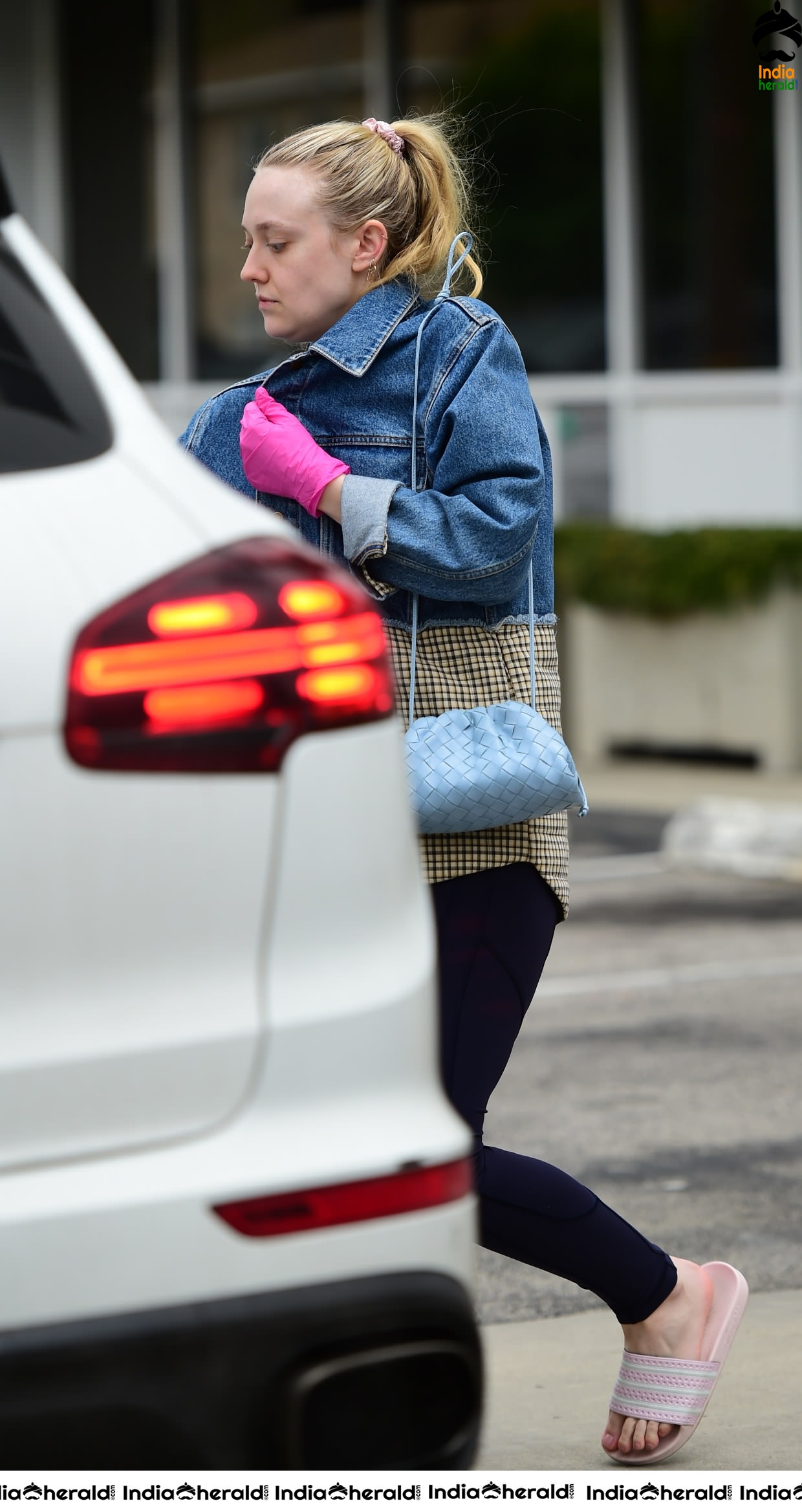 Dakota Fanning Wears pink surgical gloves while stepping out in Los Angeles