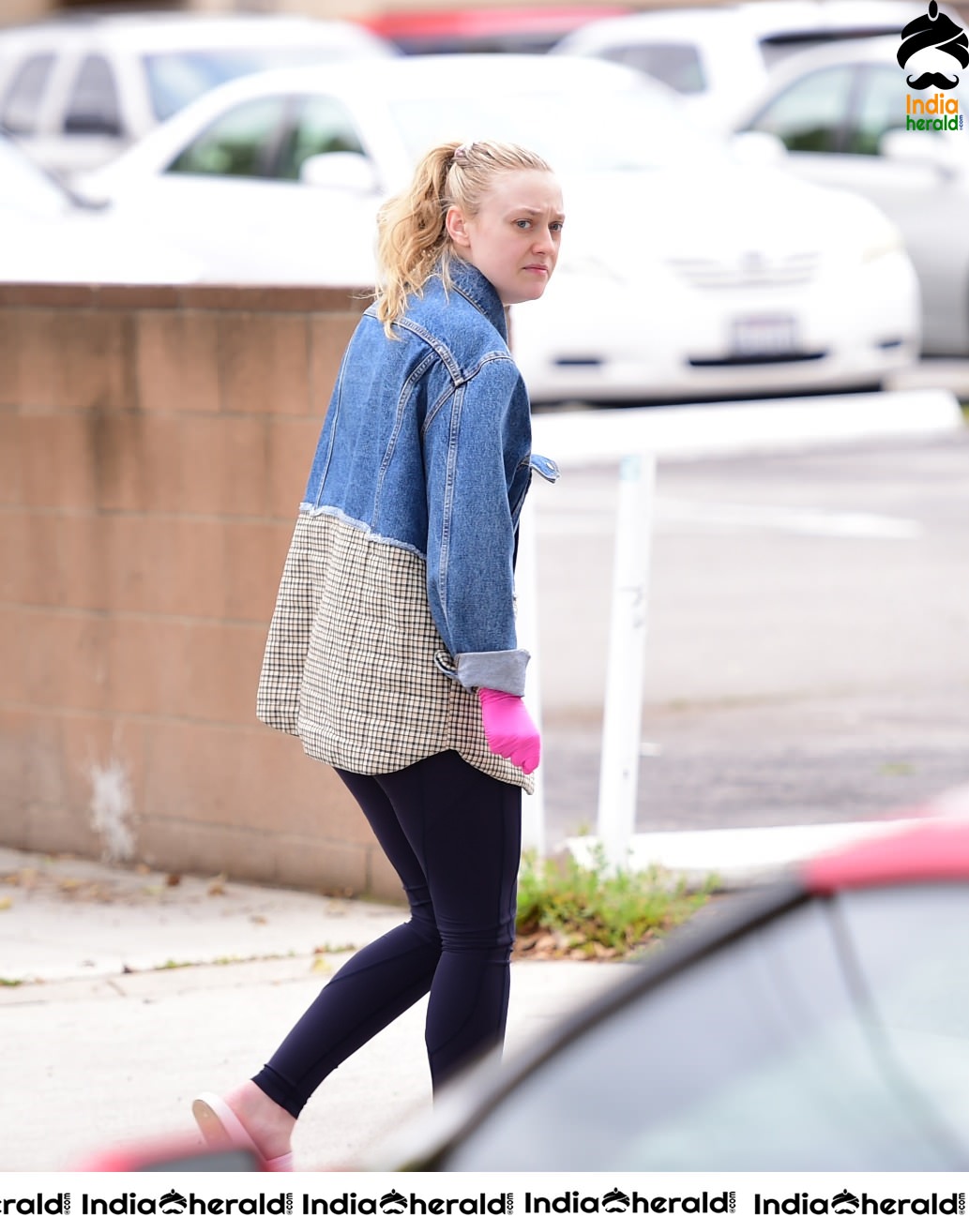 Dakota Fanning Wears pink surgical gloves while stepping out in Los Angeles