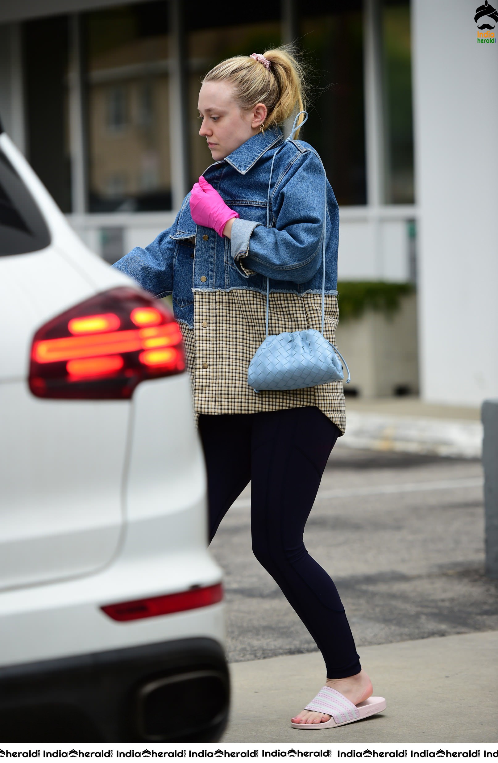 Dakota Fanning Wears pink surgical gloves while stepping out in Los Angeles