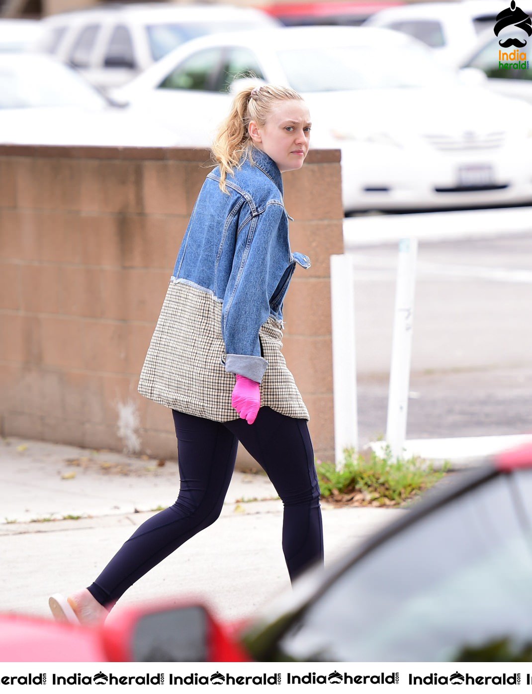 Dakota Fanning Wears pink surgical gloves while stepping out in Los Angeles