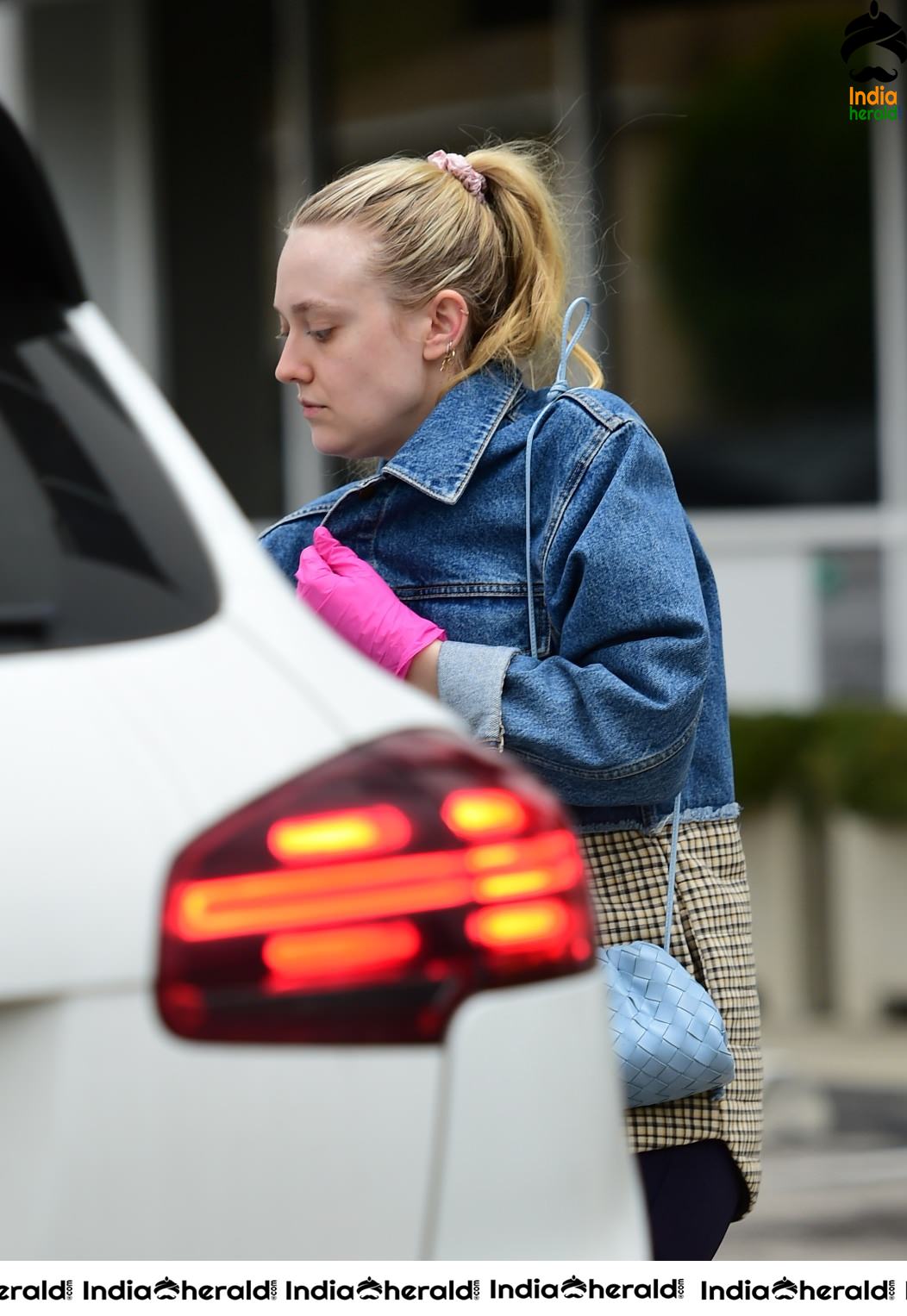 Dakota Fanning Wears pink surgical gloves while stepping out in Los Angeles