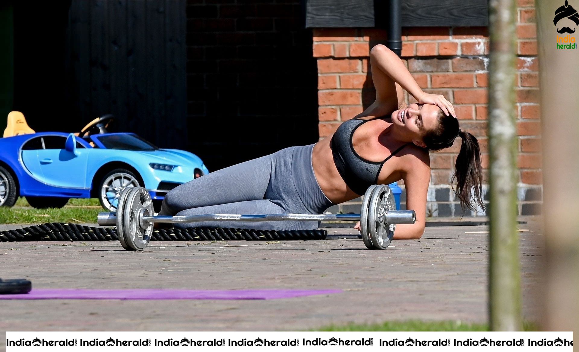 Danielle Lloyd in hot gym dress and trains on her drive in Liverpool