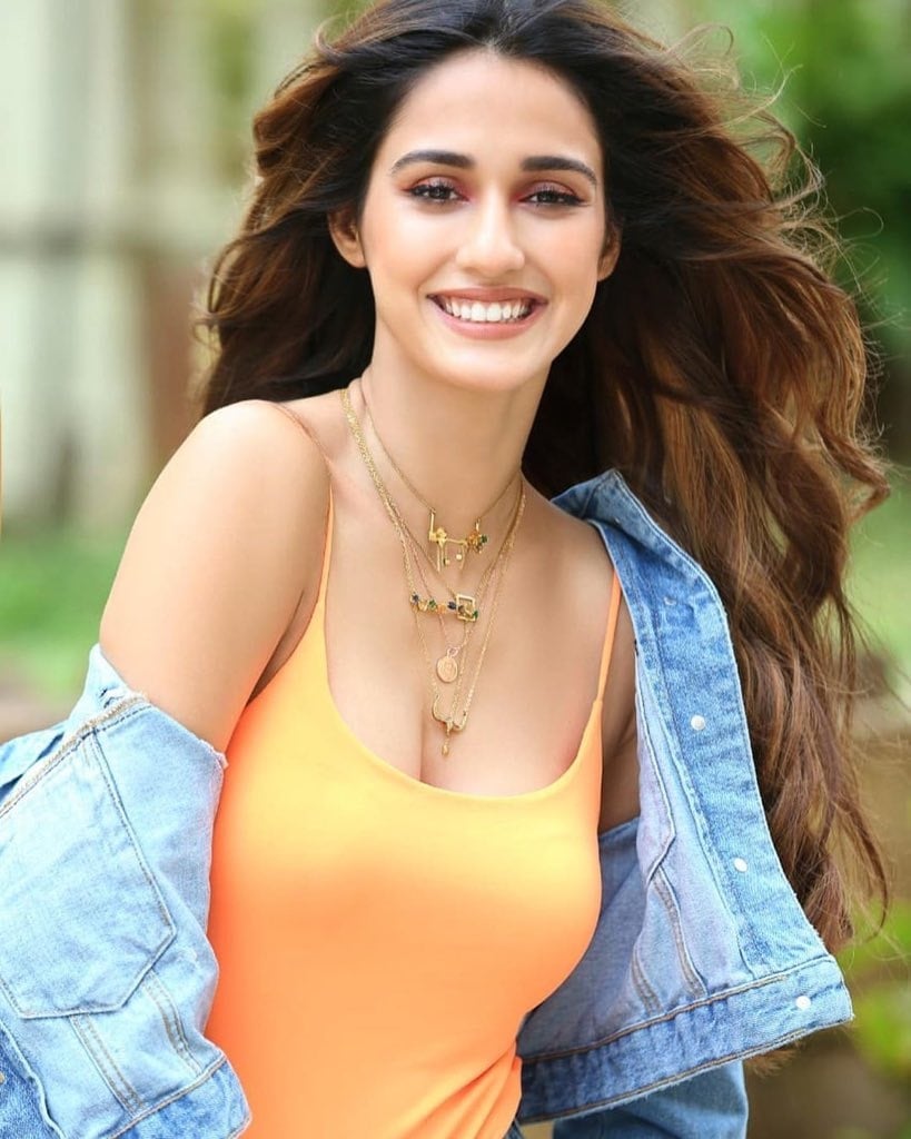 Disha Patani Raises The Temptations In A Sleeveless Orange Top And Torn Denim Coat
