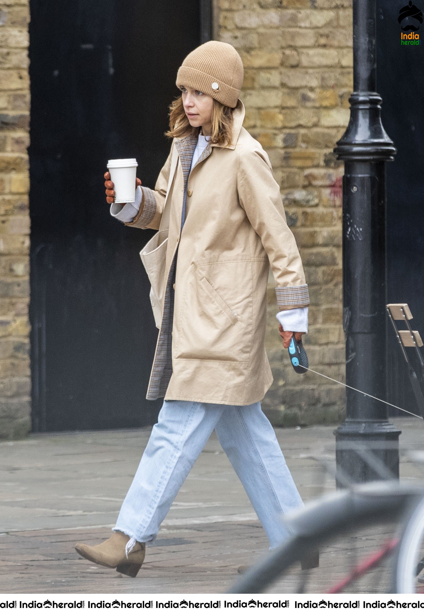 Emilia Clarke Takes her dog for a stroll as she steps out for a coffee in London