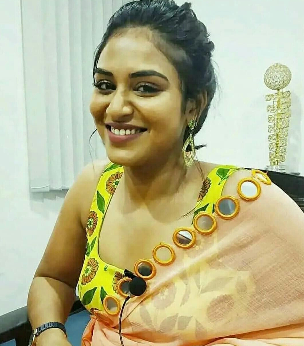 Indhuja Ravichandran Oozing Sex Appeal In Transparent Orange Saree