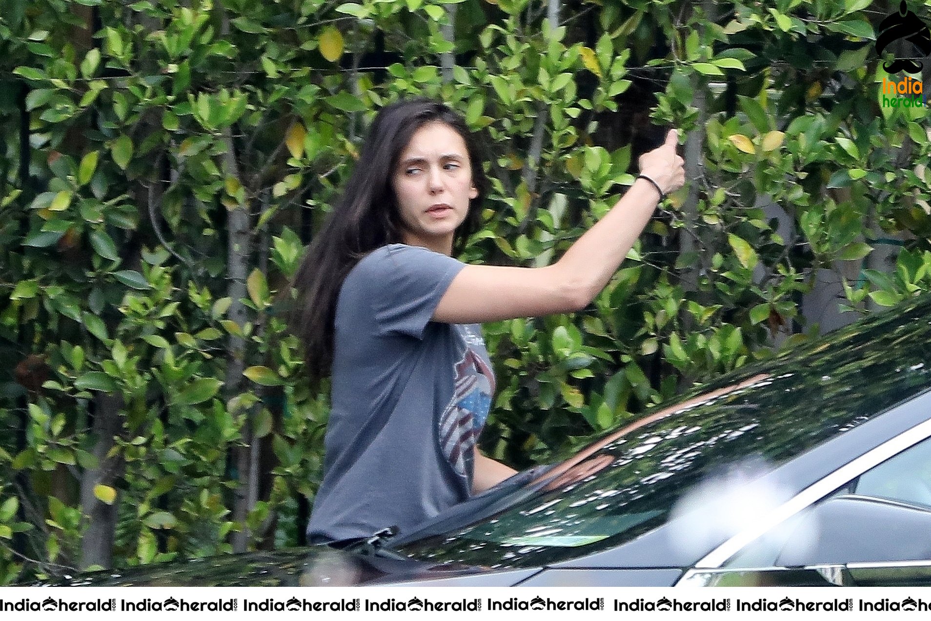 Nina Dobrev caught by Paparazzi while carrying furniture to a car in Los Angeles