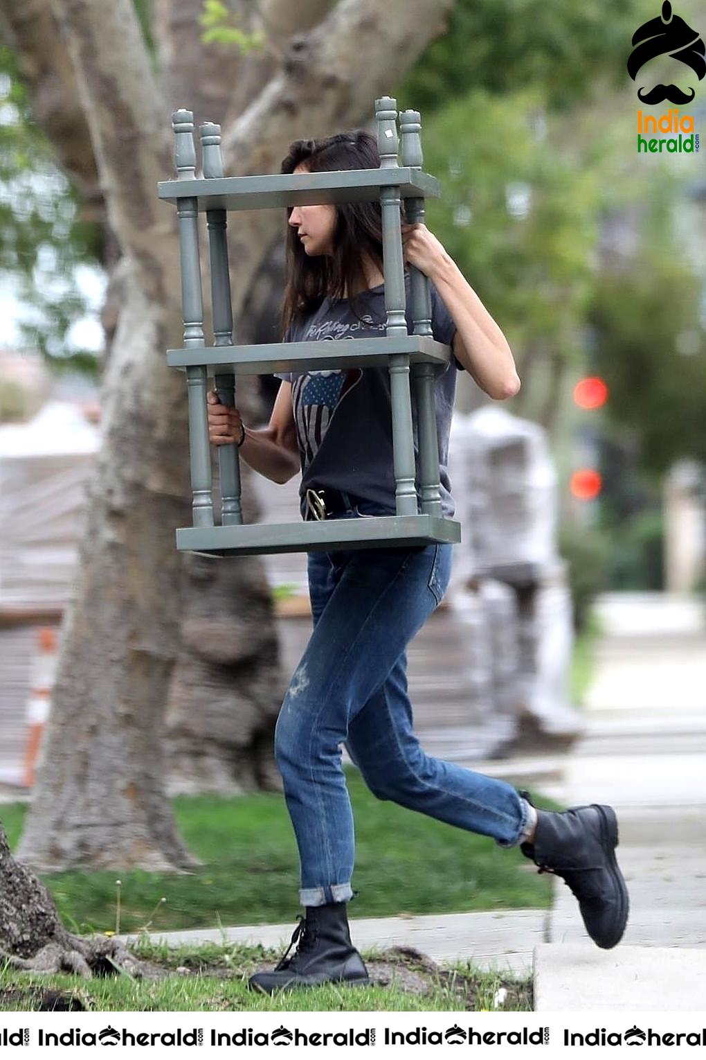 Nina Dobrev caught by Paparazzi while carrying furniture to a car in Los Angeles