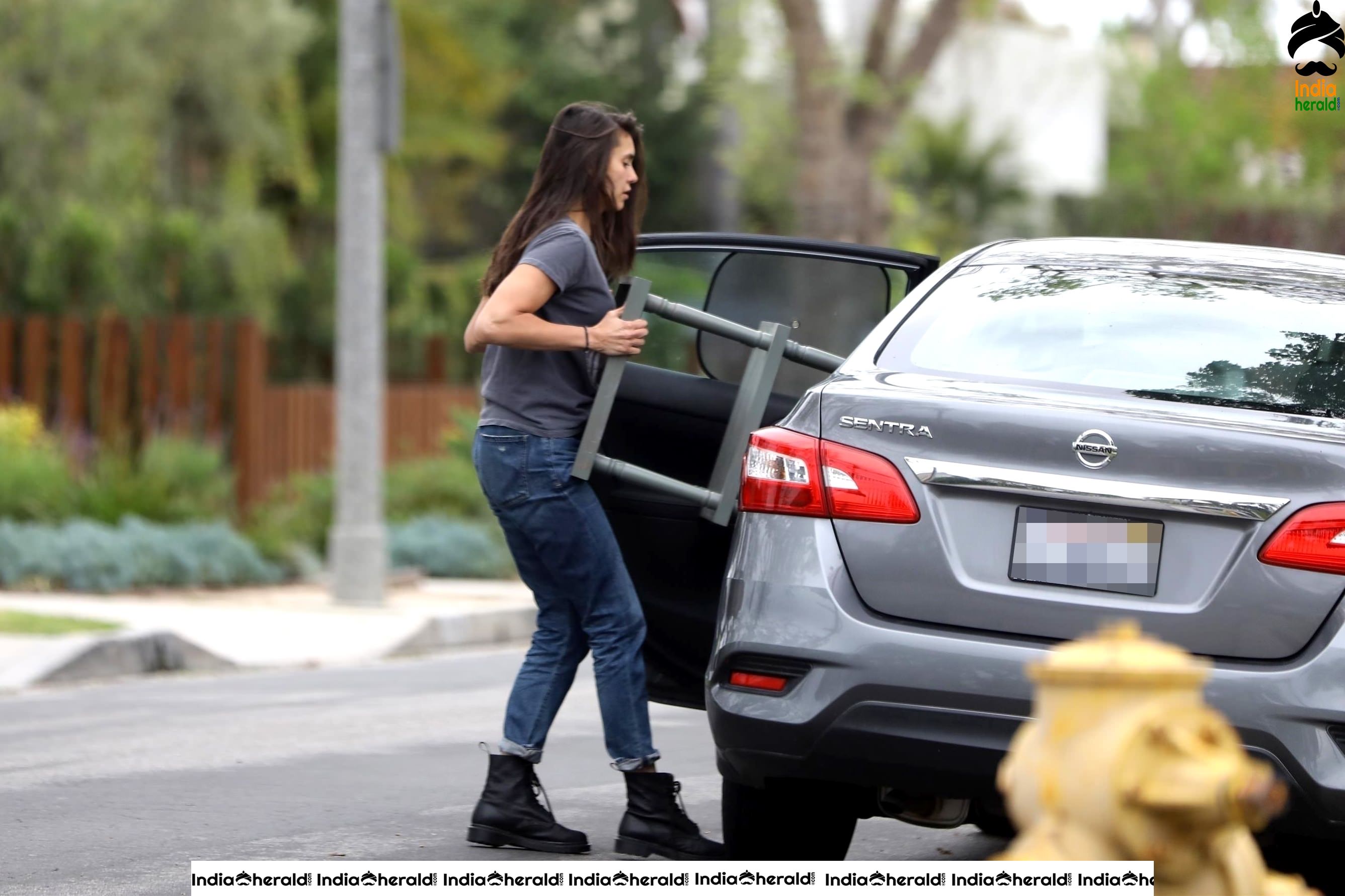 Nina Dobrev caught by Paparazzi while carrying furniture to a car in Los Angeles