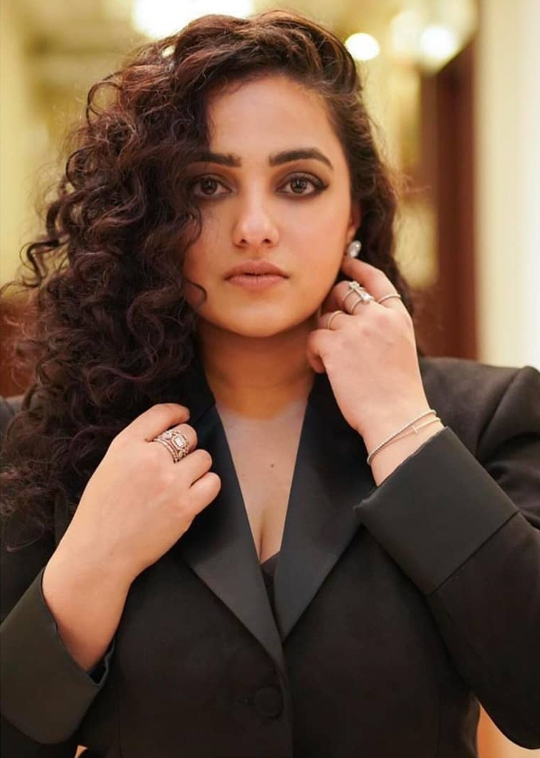 Nithya Menon Teasing Cleavage Show In Black Suit