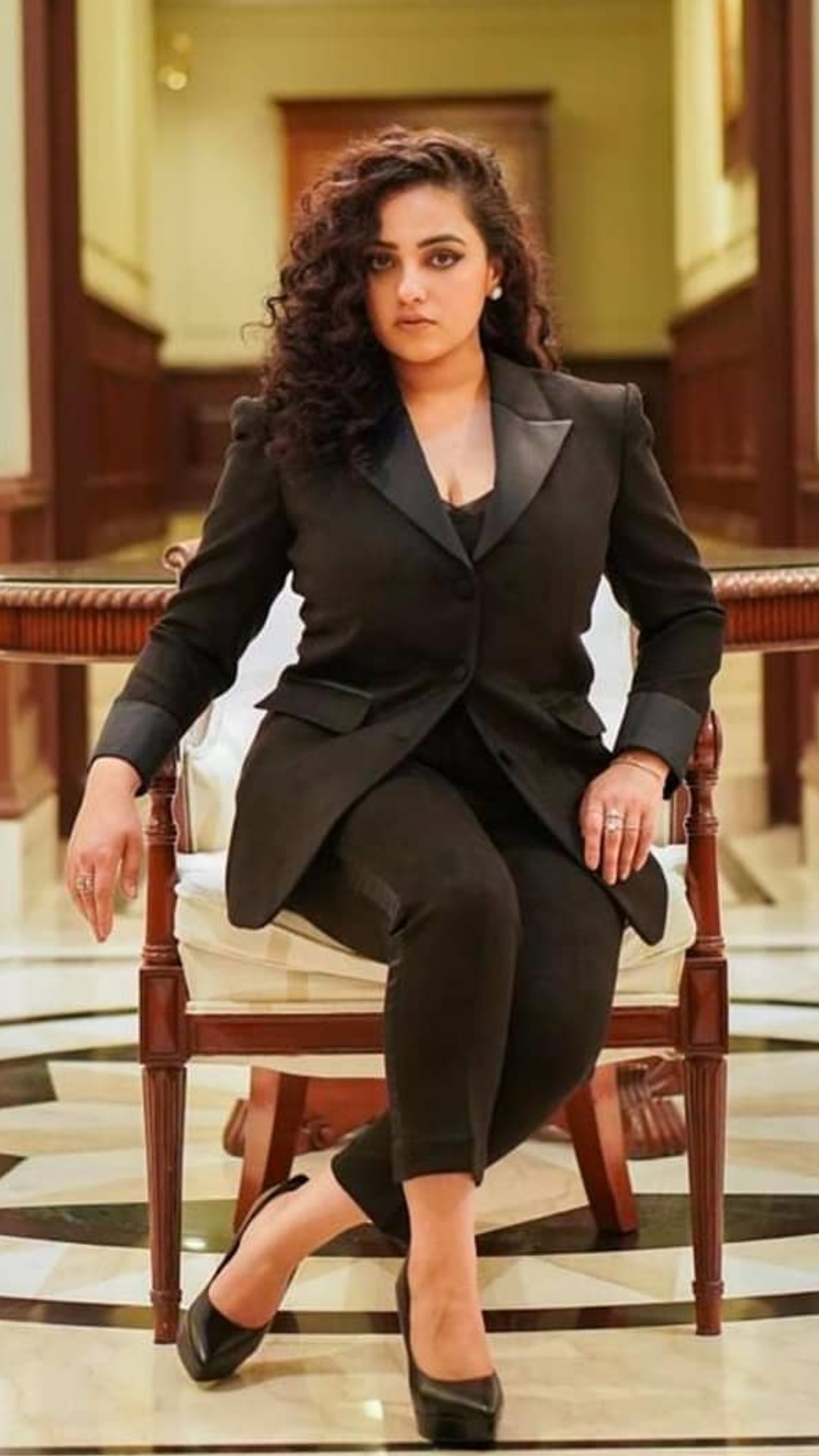Nithya Menon Teasing Cleavage Show In Black Suit