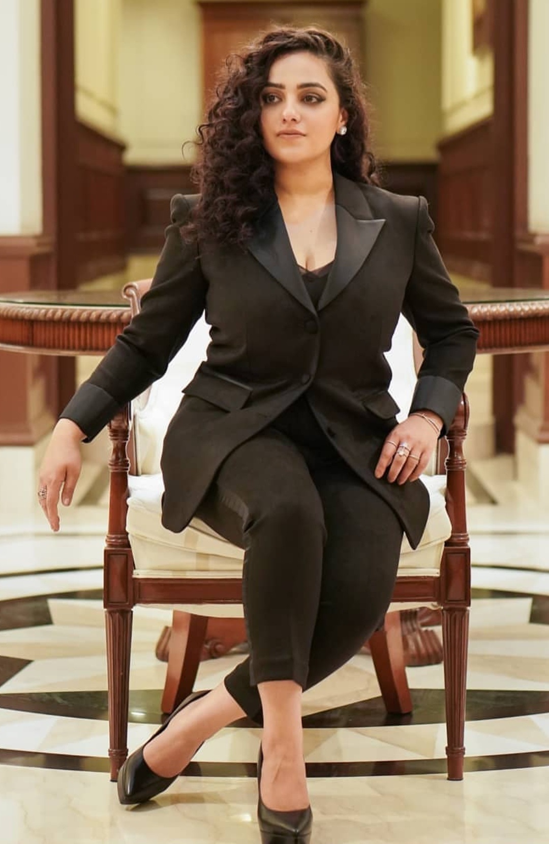 Nithya Menon Teasing Cleavage Show In Black Suit