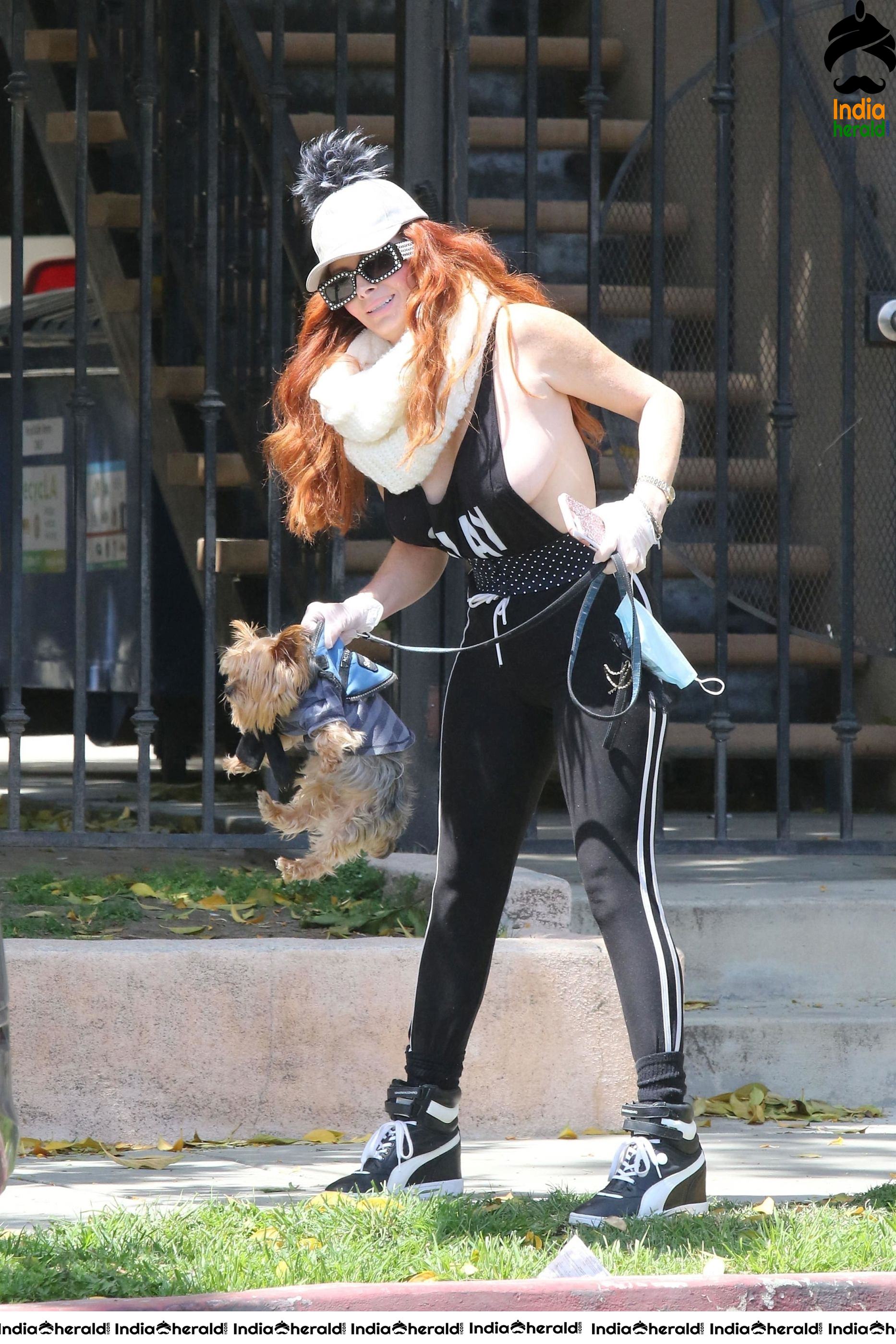 Phoebe Price shows off a new mask as she walks her dog in LA