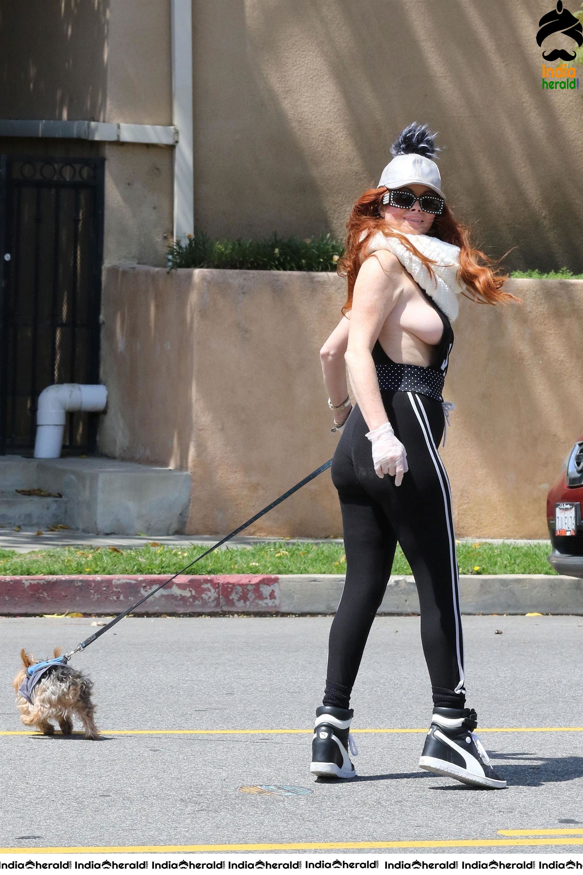 Phoebe Price shows off a new mask as she walks her dog in LA