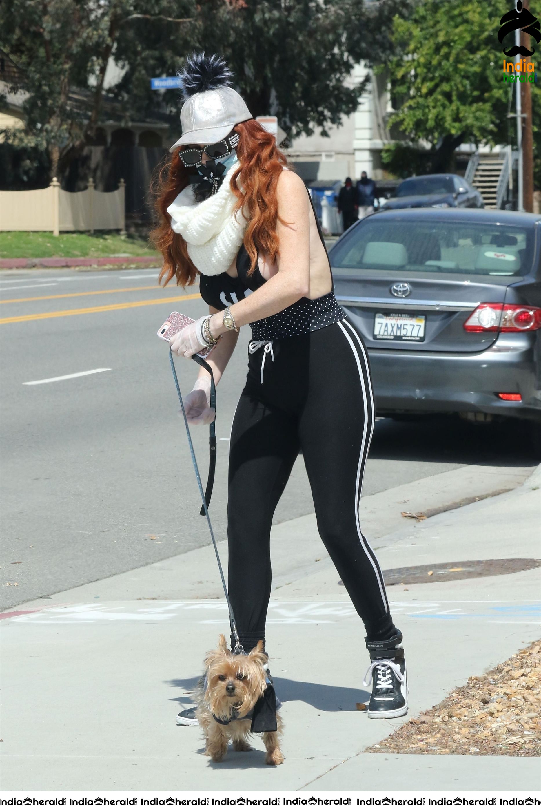 Phoebe Price shows off a new mask as she walks her dog in LA