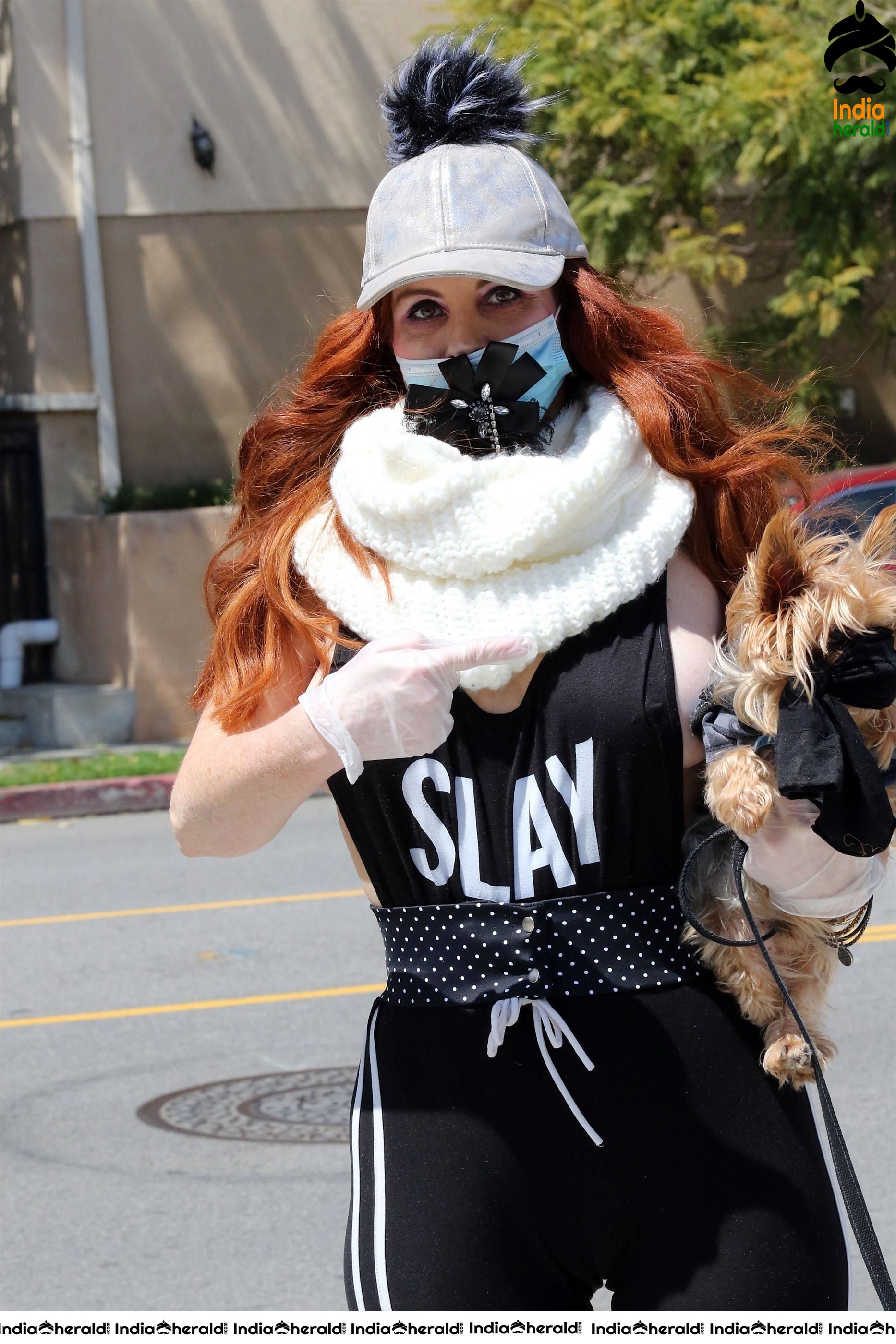 Phoebe Price shows off a new mask as she walks her dog in LA