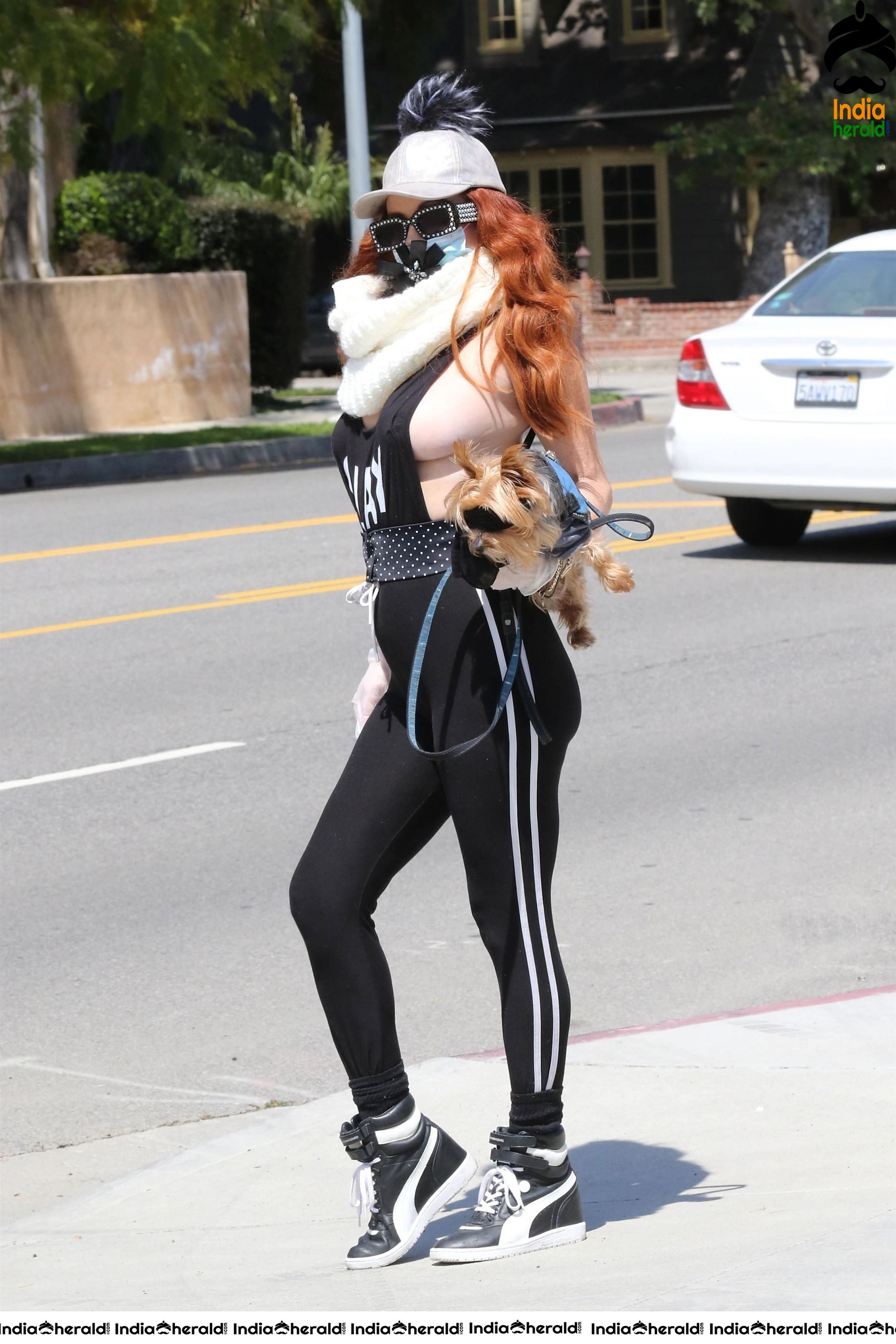 Phoebe Price shows off a new mask as she walks her dog in LA