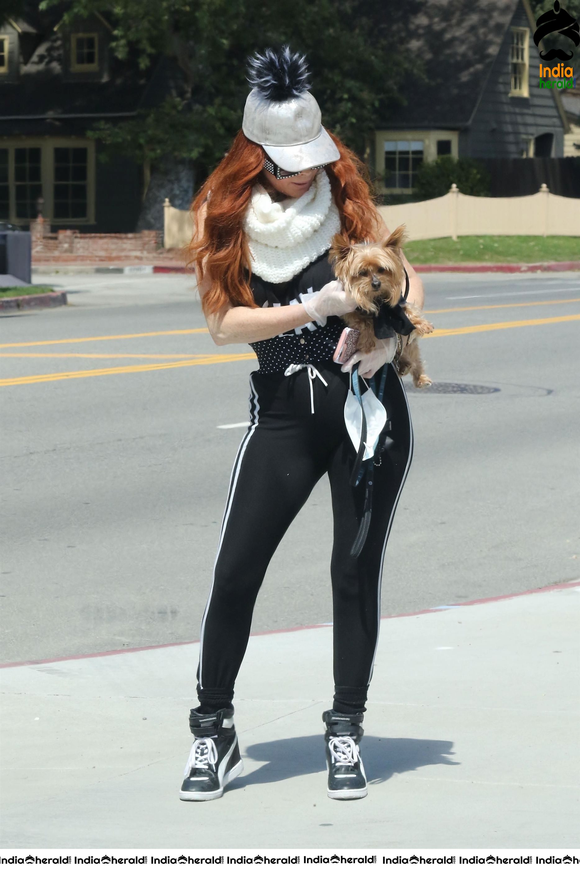 Phoebe Price shows off a new mask as she walks her dog in LA