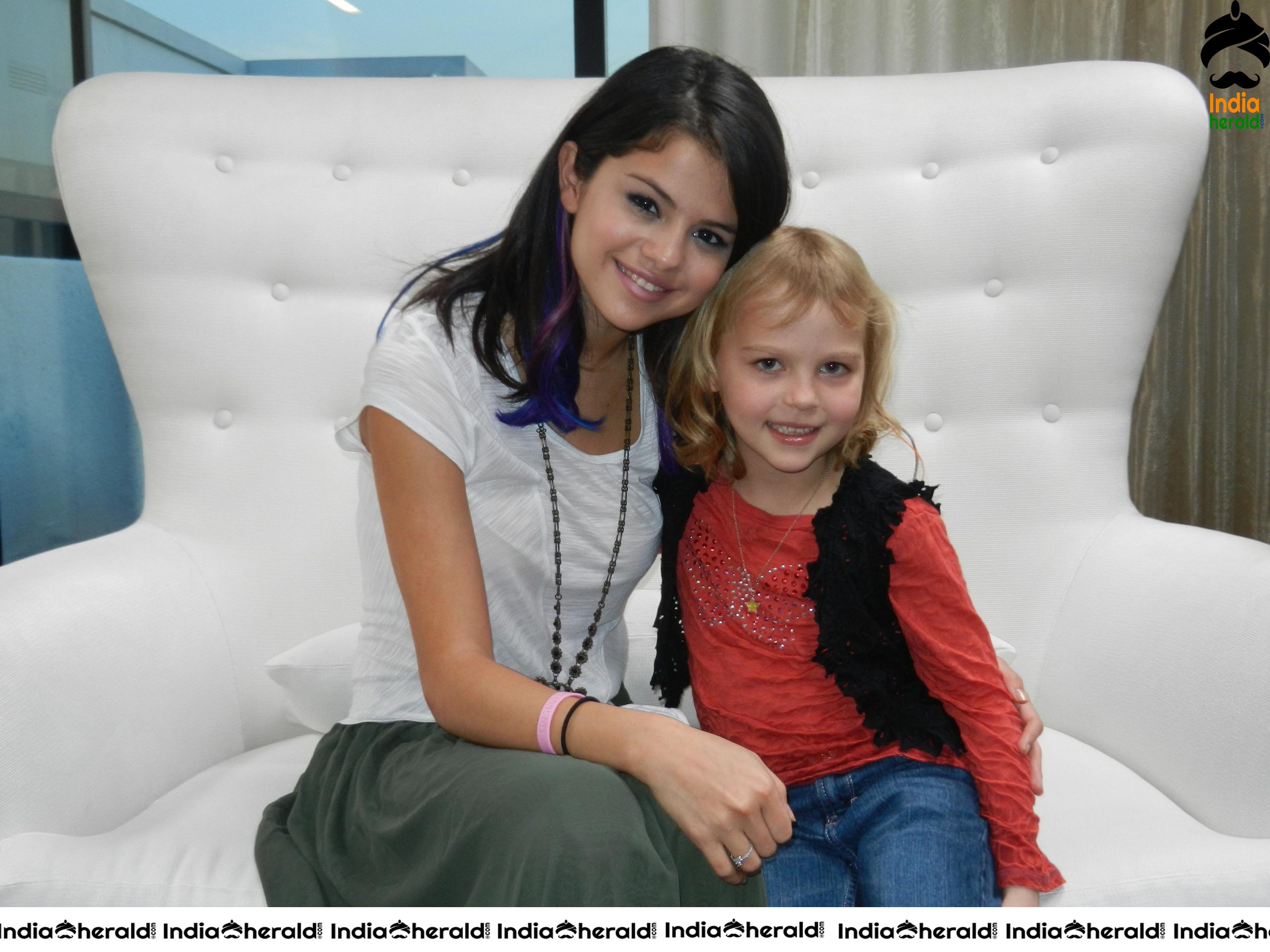 Selena Gomez poses happily with the fans after the Charity event