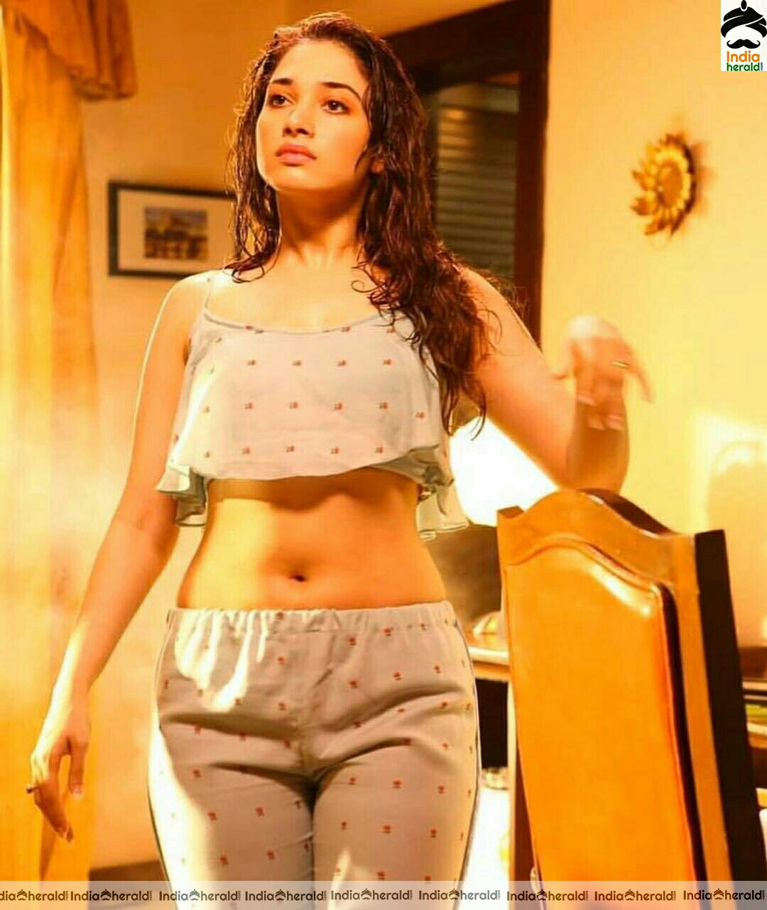 Tamanna arouses temptations by getting wet and Exposing her navel in these hot photos