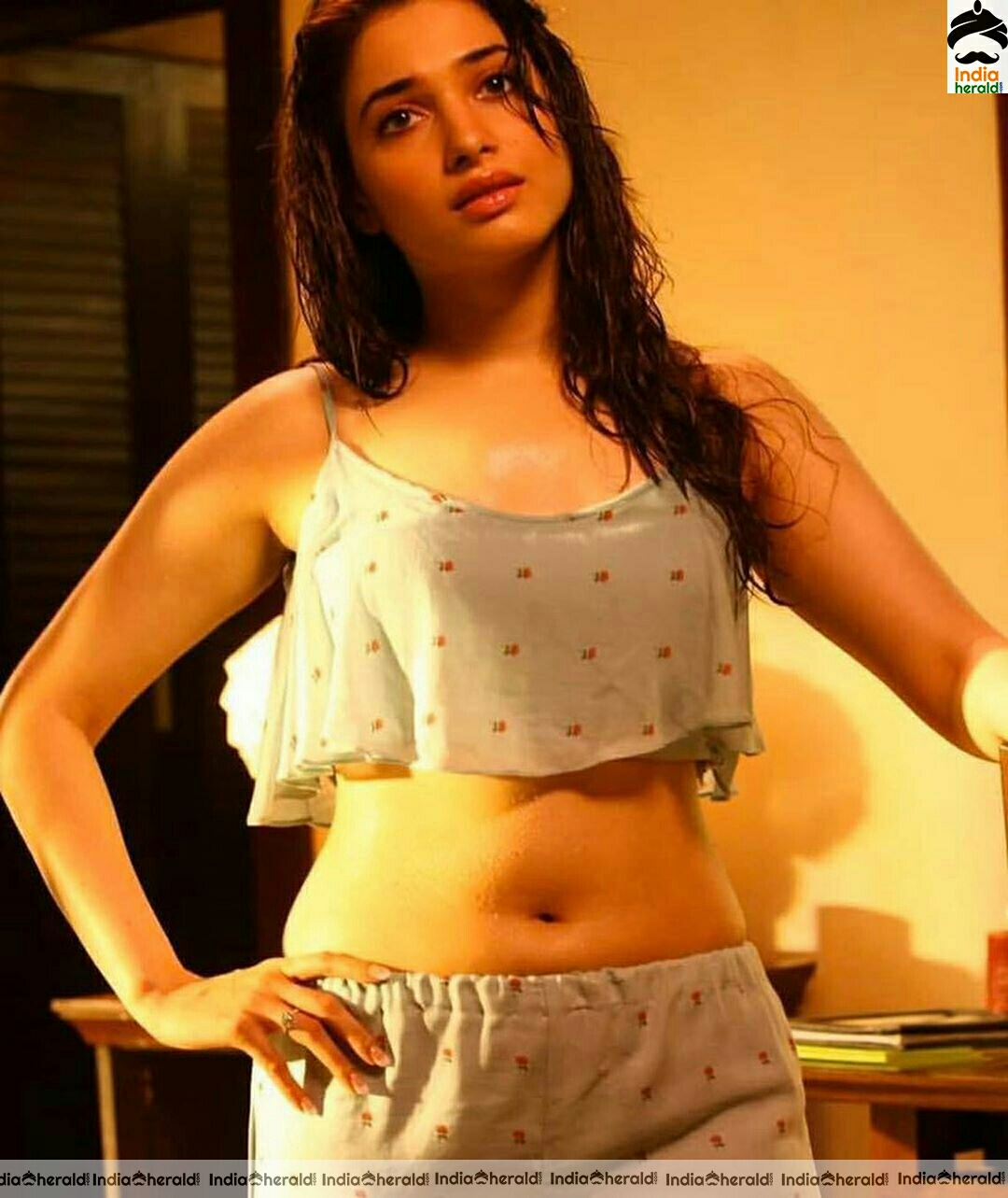 Tamanna arouses temptations by getting wet and Exposing her navel in these hot photos