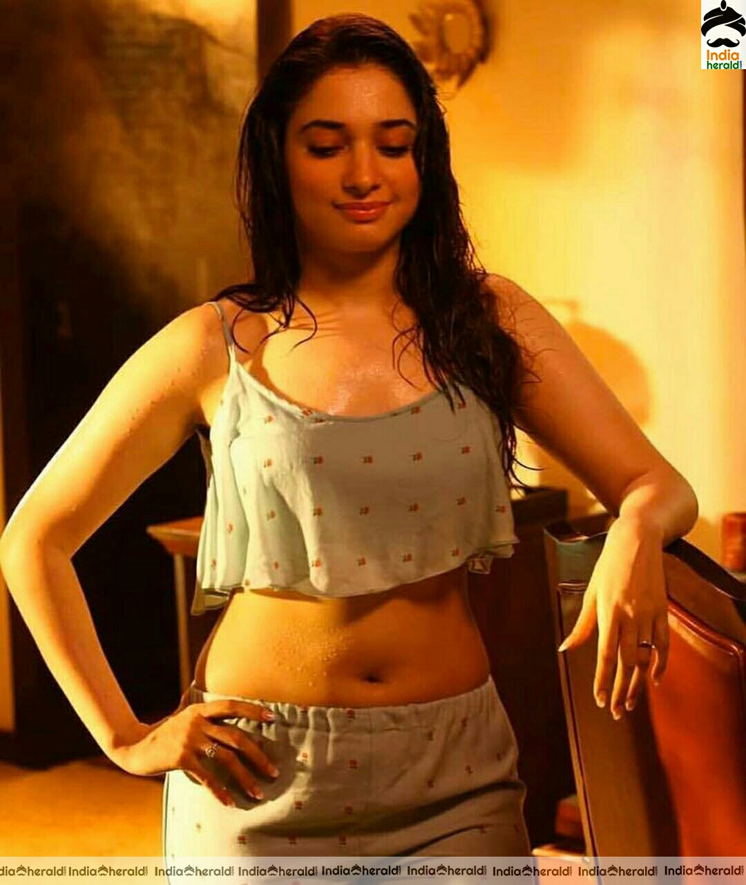 Tamanna arouses temptations by getting wet and Exposing her navel in these hot photos