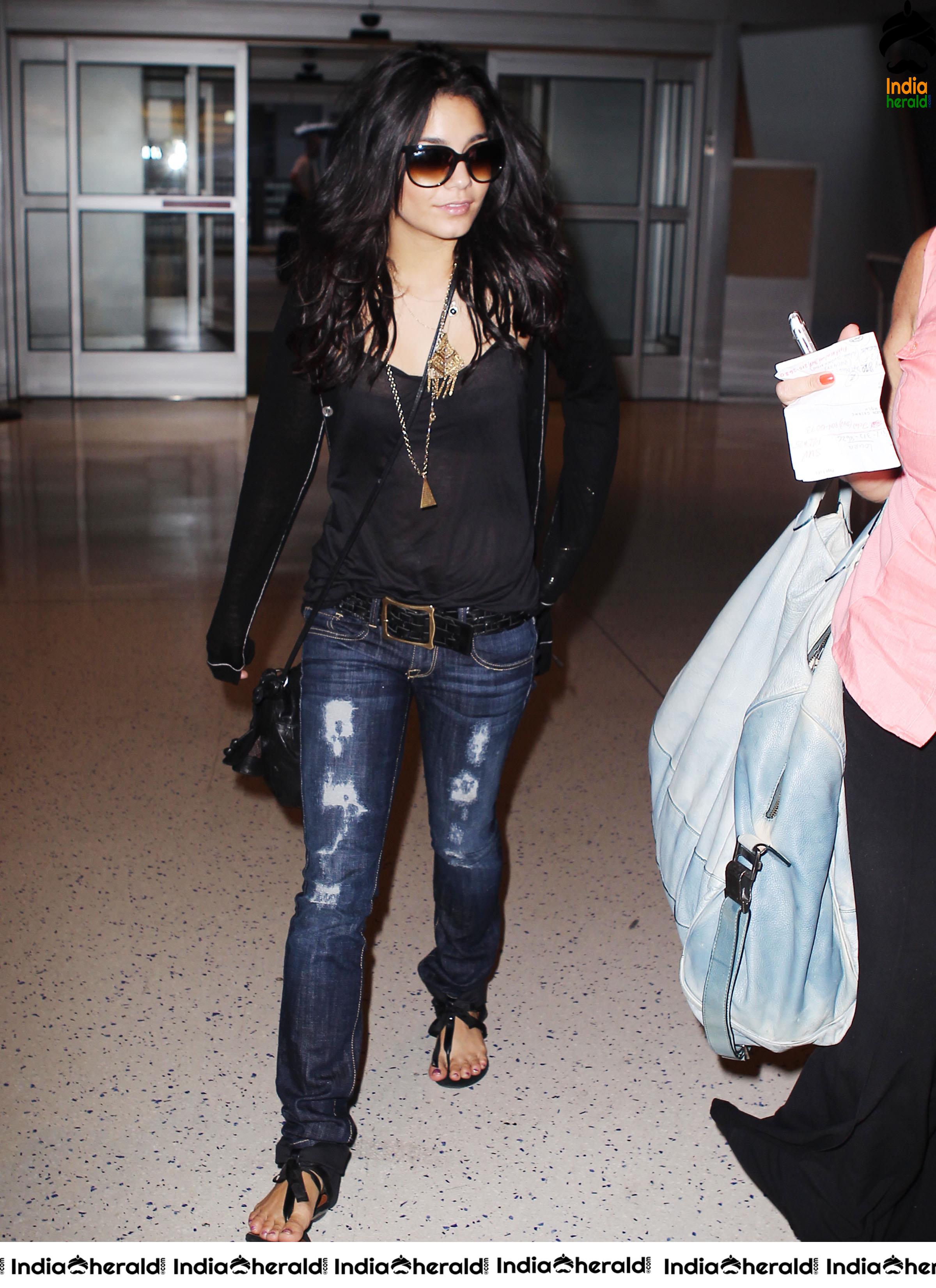 Vanessa Hudgens Exposing her Brassiere in a Transparent Black Top at JFK Airport