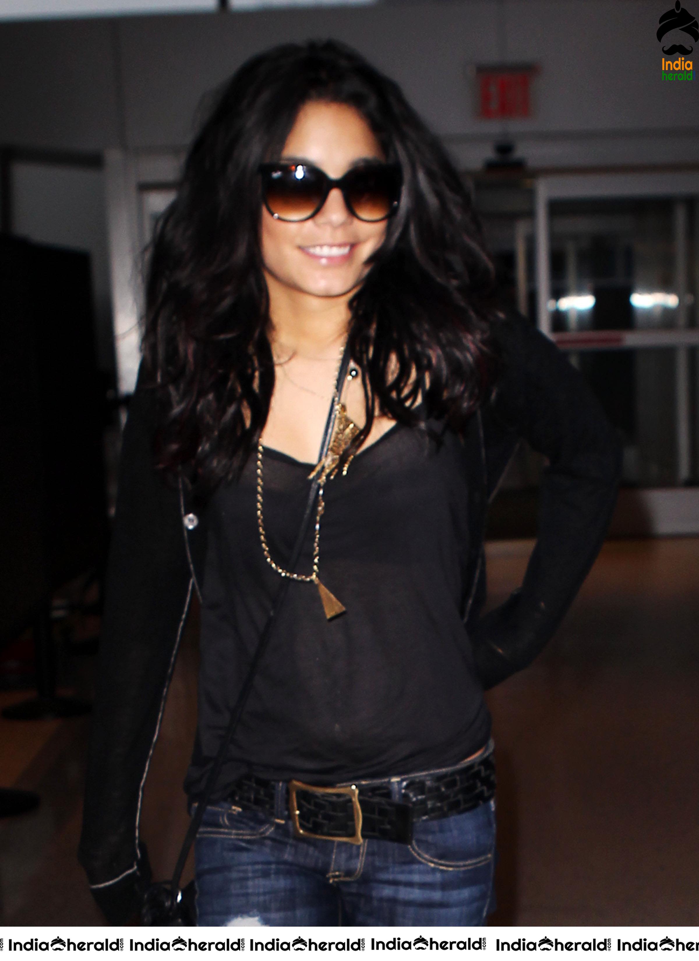 Vanessa Hudgens Exposing her Brassiere in a Transparent Black Top at JFK Airport