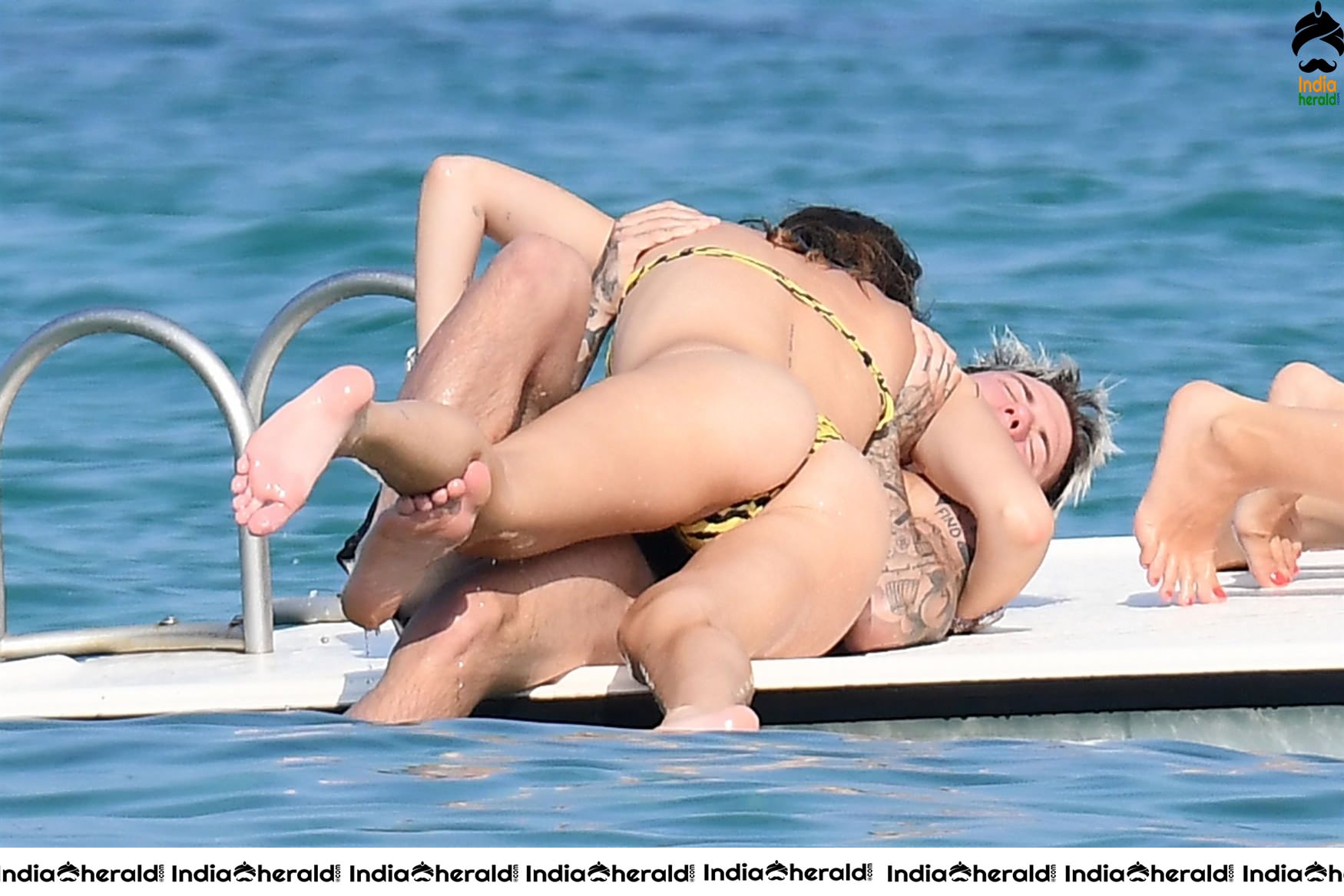 Bella Thorne in Yellow Striped Bikini and Enjoys with her Boyfriend in a Beach in Maywood