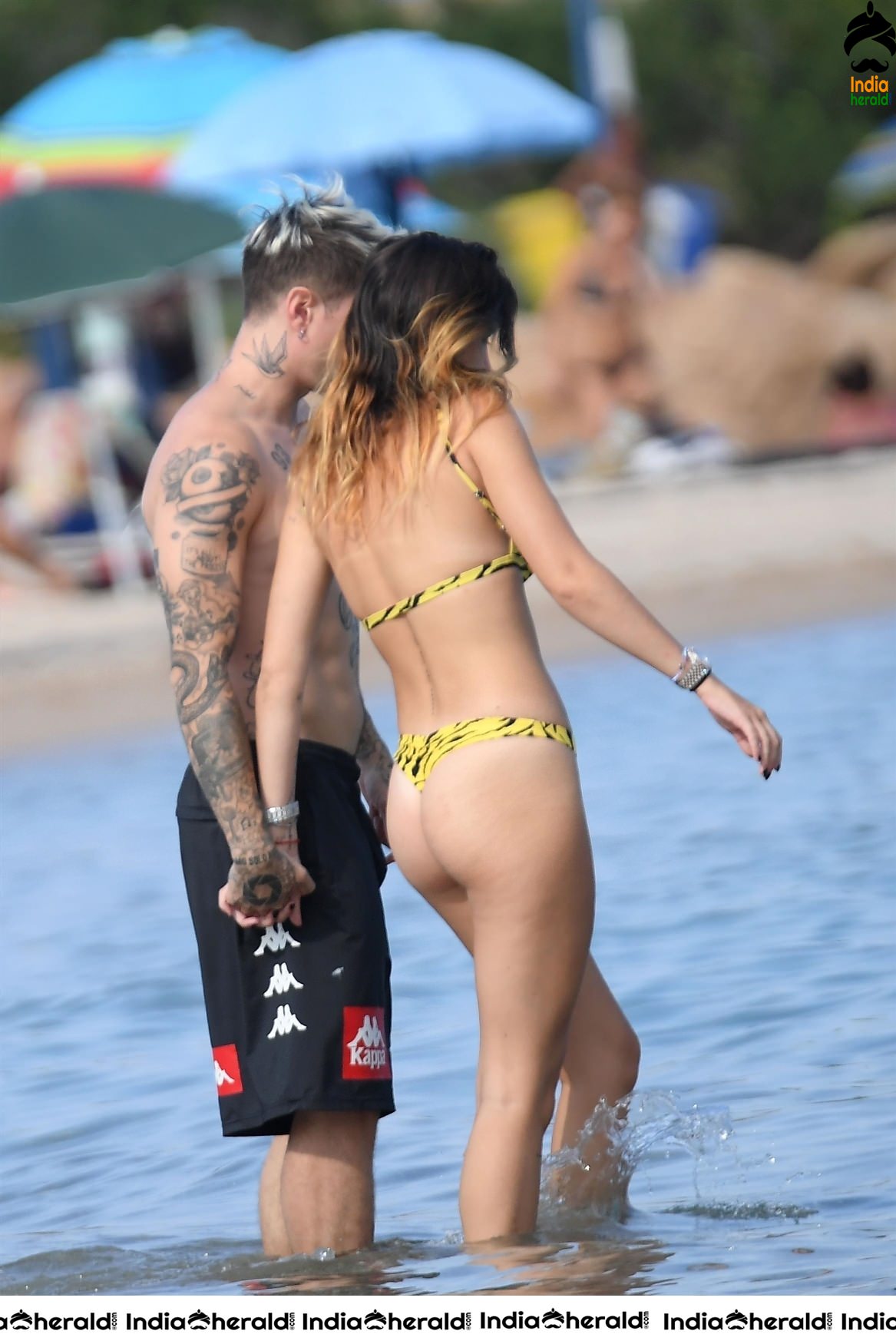 Bella Thorne in Yellow Striped Bikini and Enjoys with her Boyfriend in a Beach in Maywood