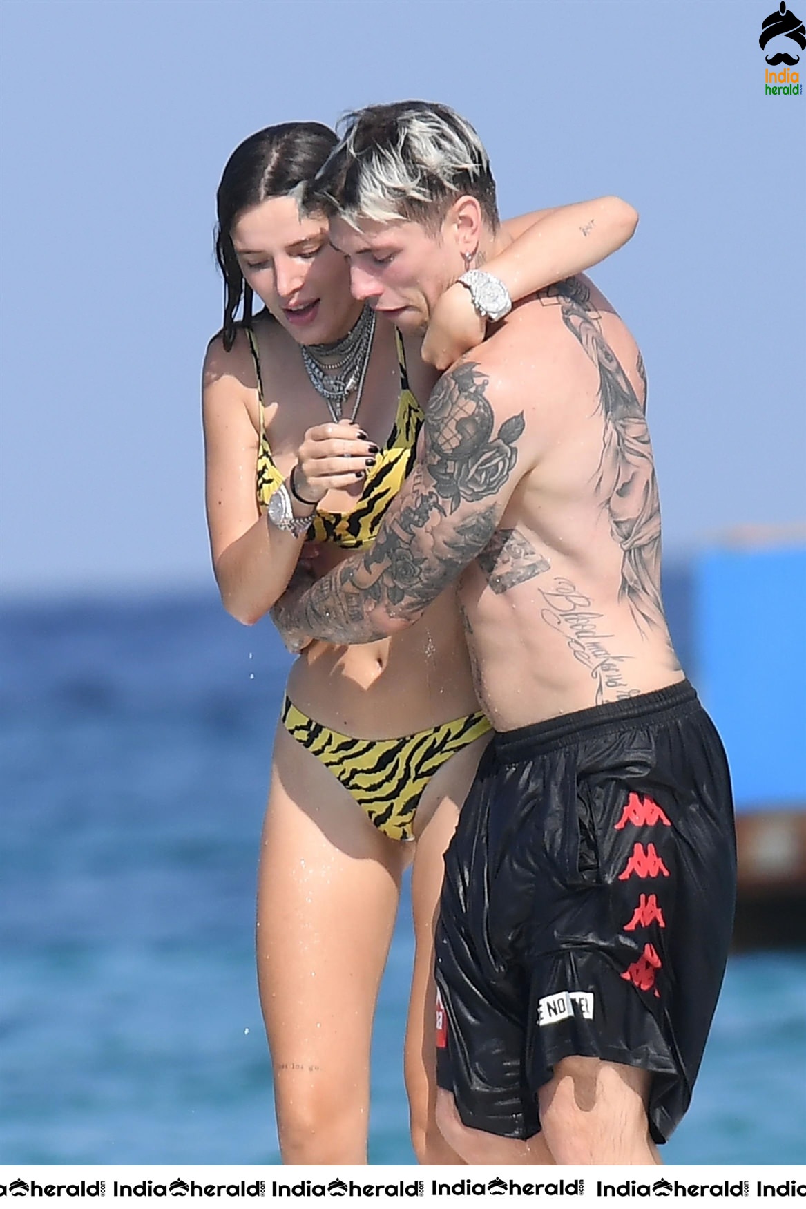 Bella Thorne in Yellow Striped Bikini and Enjoys with her Boyfriend in a Beach in Maywood