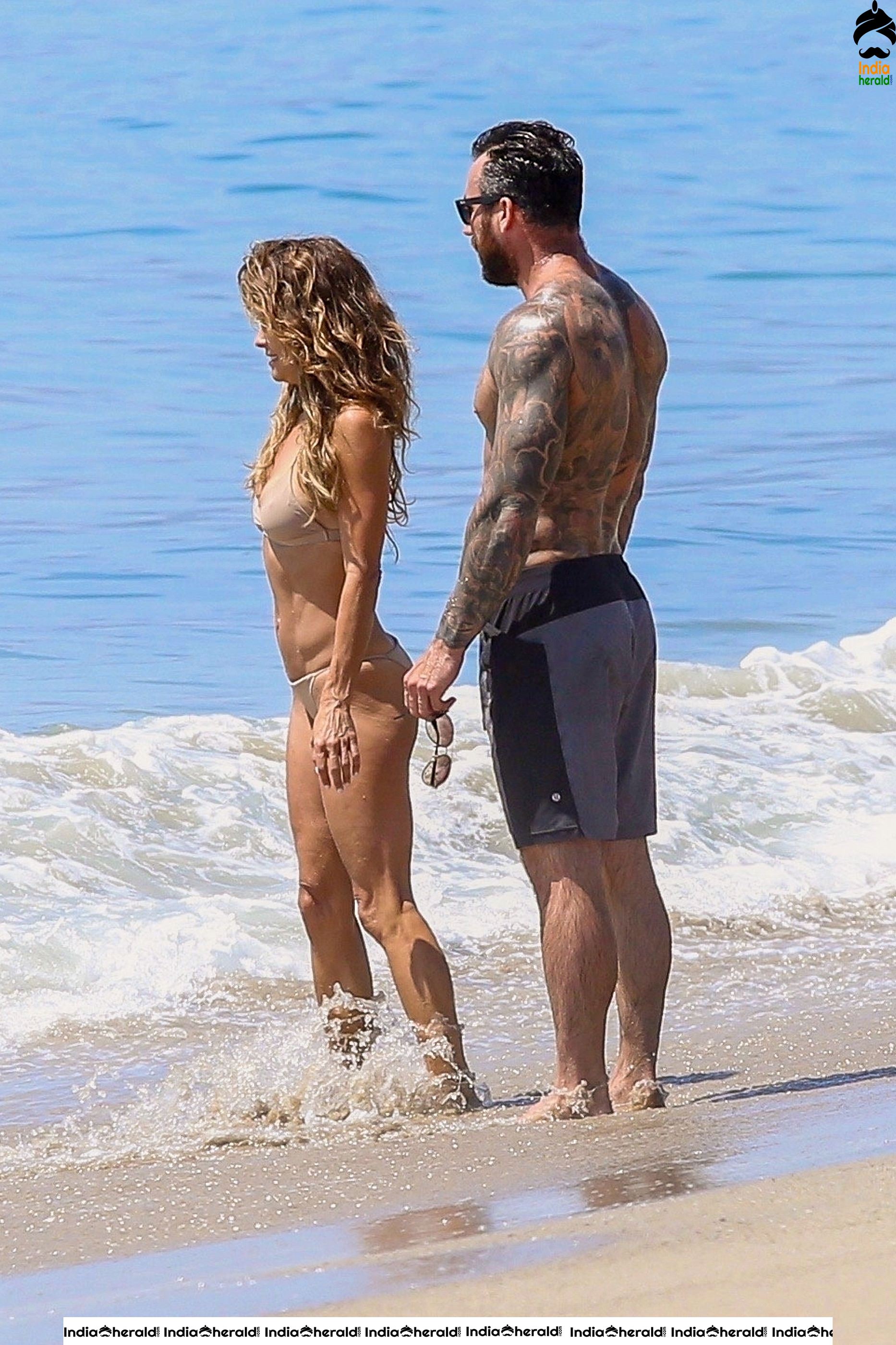 Brooke Burke in Bikini and Enjoying with Boyfriend by Getting Wet on Beach Set 2