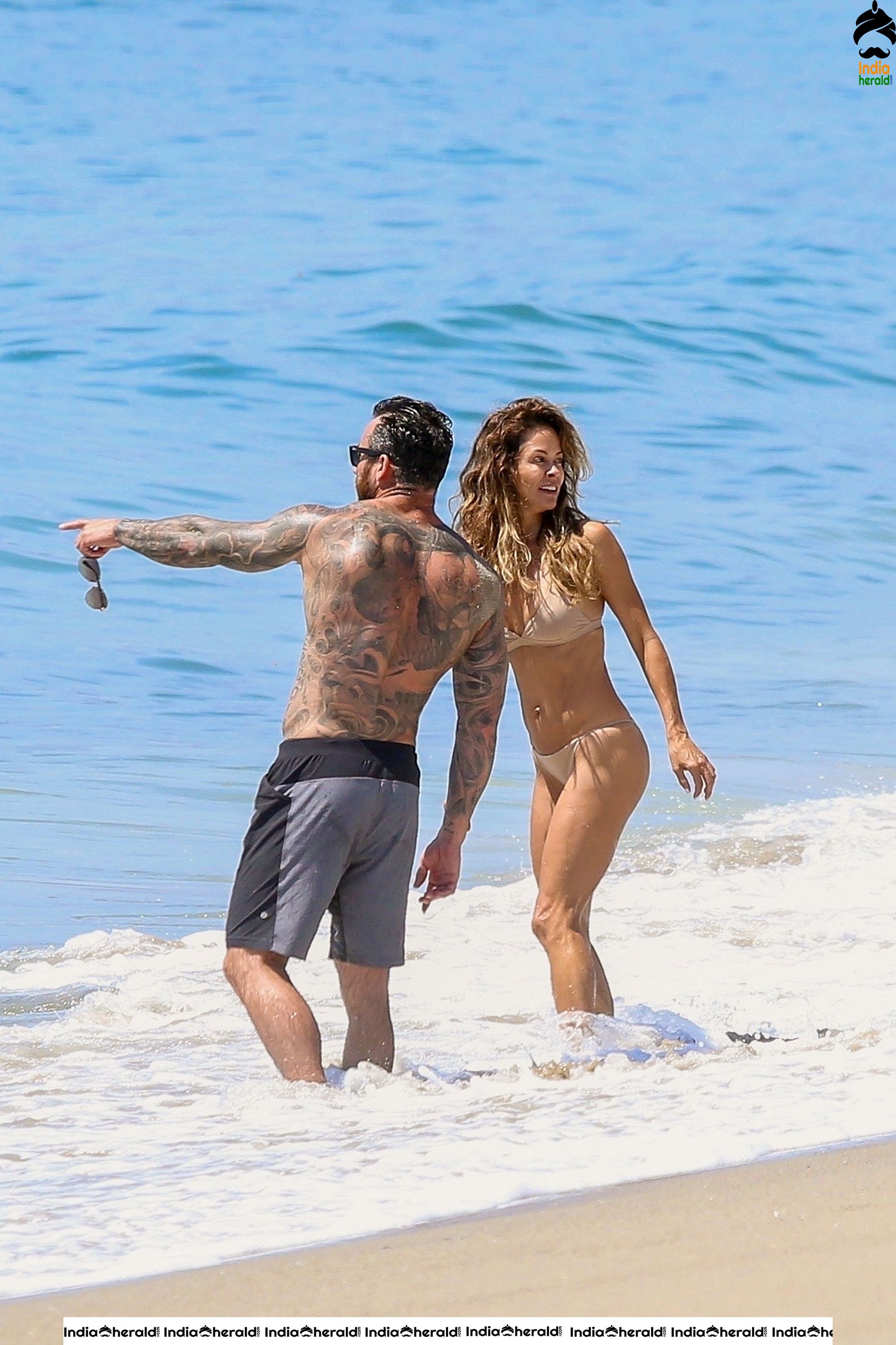 Brooke Burke in Bikini and Enjoying with Boyfriend by Getting Wet on Beach Set 2