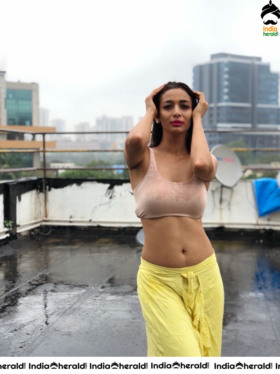 Heena Panchal Wearing a Sports Bra and Exposing her Hot Body on Roof Top while enjoying Rain