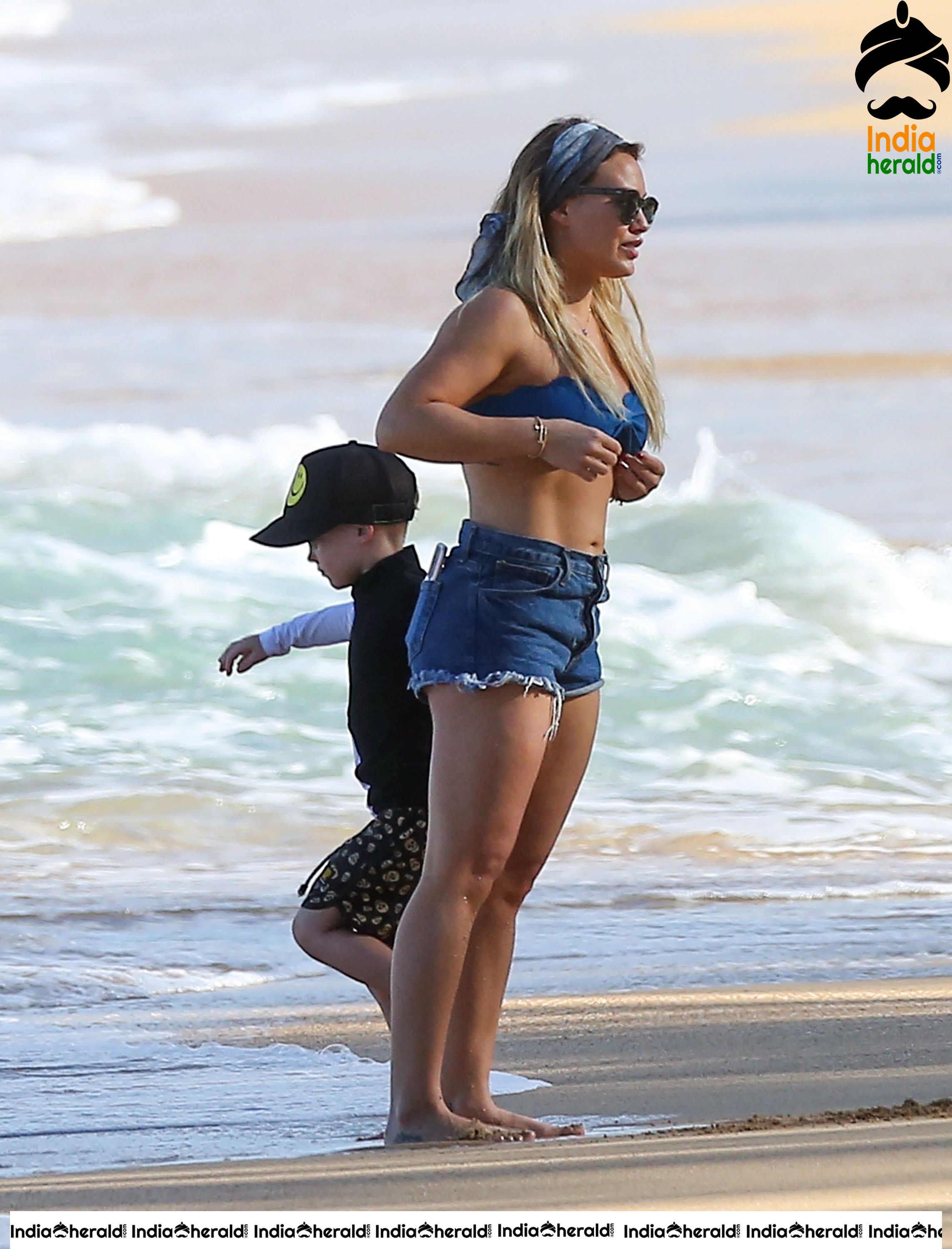 Hilary Duff Wearing a bikini top and shorts at the beach in Hawaii Set 1